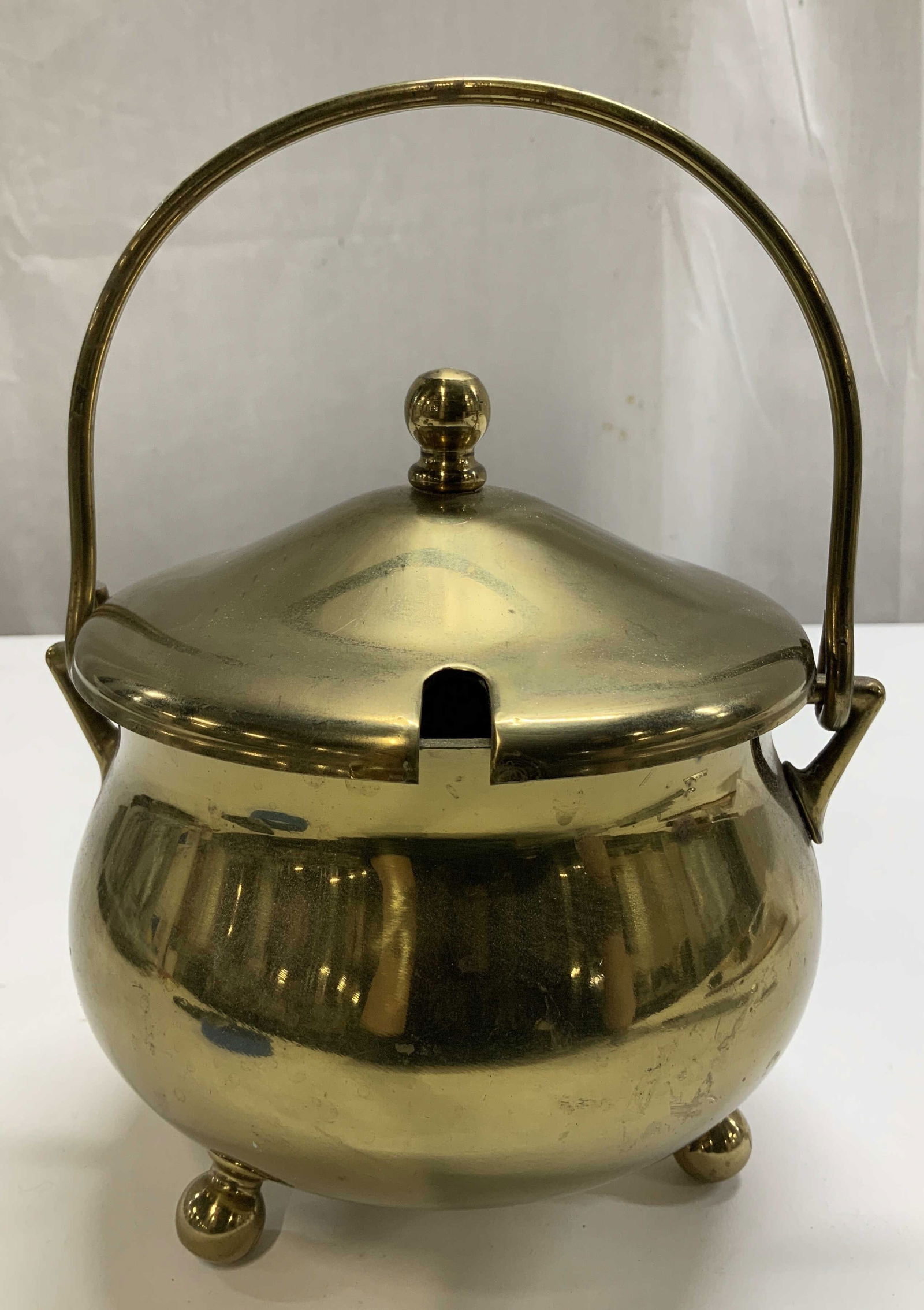 Vtg Solid Brass Smudge Pot W Lid: Vintage solid brass smudge pot features a cauldron shape, 3 ball shaped feet & lid with slot. Smudge pot has weight. No visible signature or markings. Surface wear consistent to age, use & exposure. M