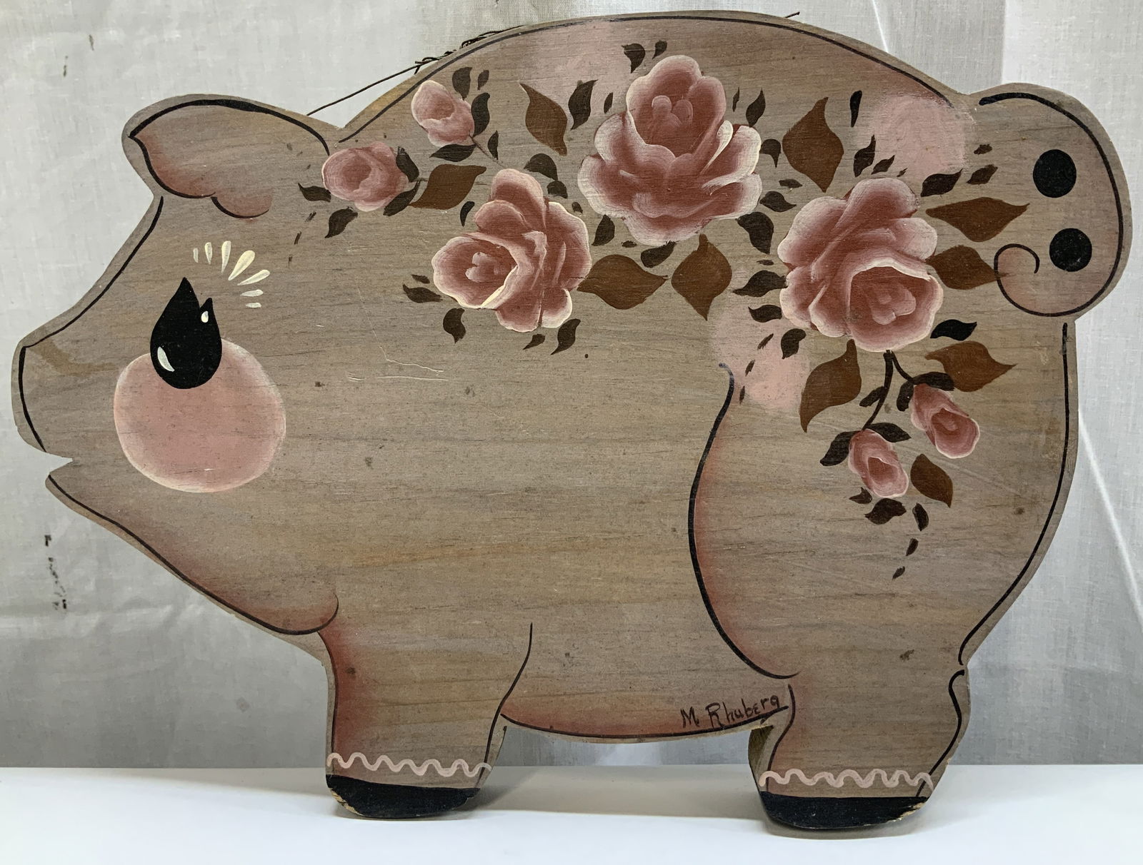 Vtg Sgnd Hand Painted Wooden Pig Wall Decor: Vintage wooden pig wall decor featuring hand painted pink floral motifs. Shades of black, brown, pink & white. Signed & marked. Reads, M. Rhuberg. Surface wear consistent to age, use & exposure.