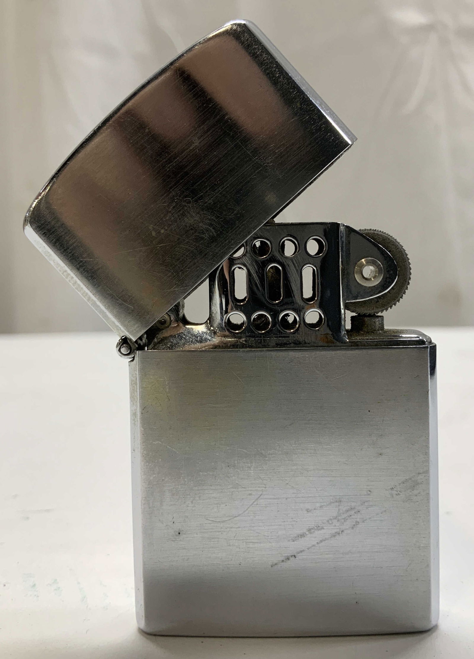 Vtg Silver Toned Pocket Lighter JAPAN: Vintage silver toned pocket lighter features a rectangular body & flip top. Signed & marked on underside. Reads, JAPAN. Surface wear consistent to age, use & exposure. Measurements: length 1.7in x wid