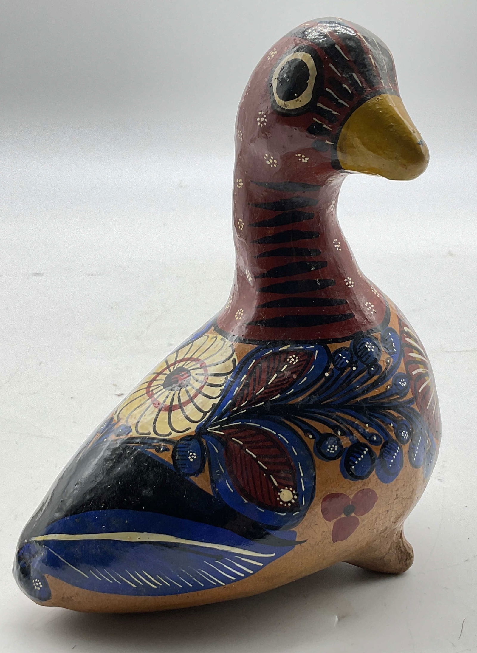 Vtg Mexican Folk Art Style Ceramic Duck Figurine: Vintage Mexican Folk Art style ceramic duck figurine. Duck figure with two feet on underside. Hand painted floral and feather motifs. Hand painted features. Blue, black, red, etc. Measures approx
