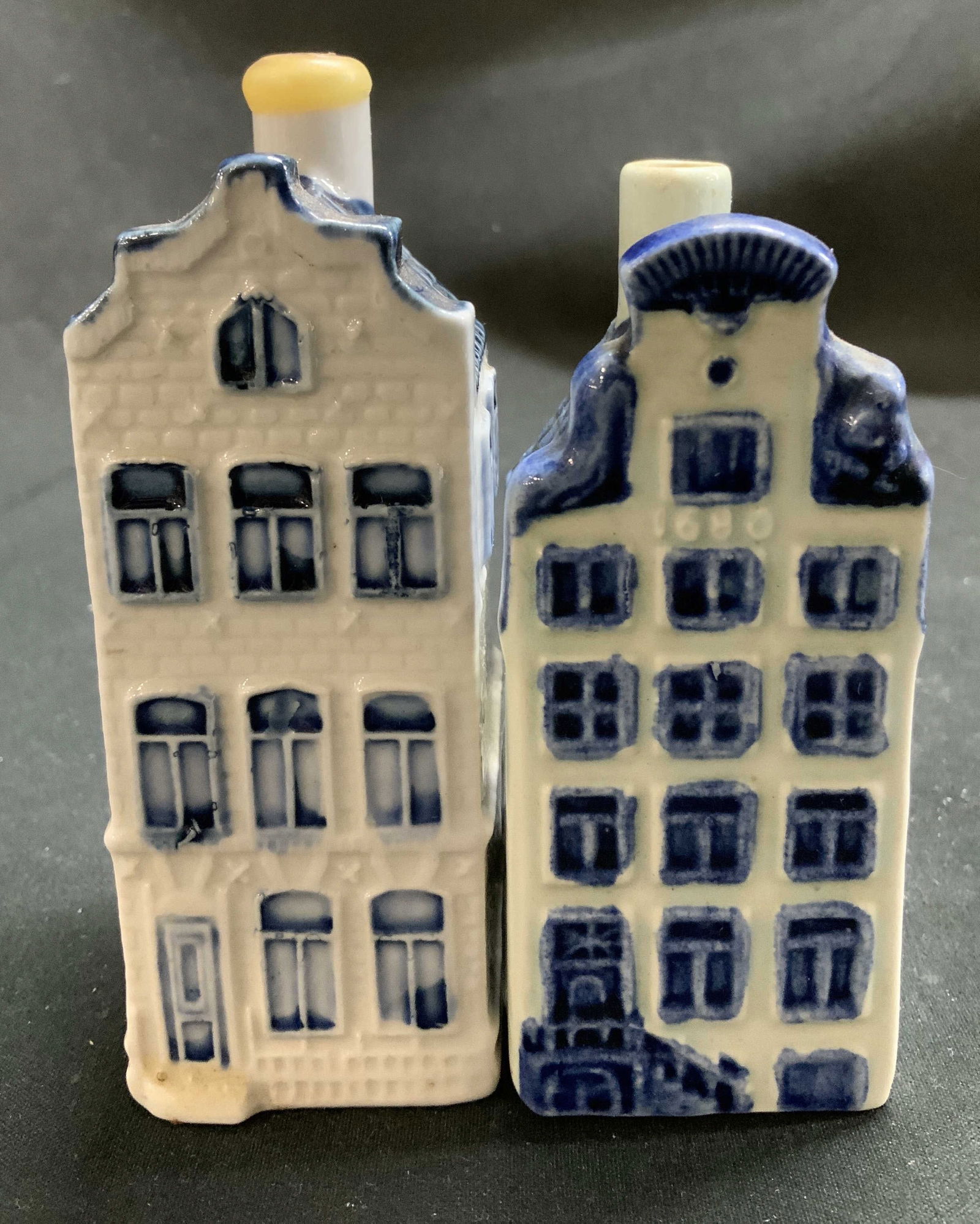 Lot 2 Royal Delft BOLS KLM Porc House Figs Holland: Lot includes, 2 porcelain house figurines featuring blue & white tones. Textured details. Opening at top. Sold as is. Signed & marked on underside. Reads, ROYAL DELFT BLUE HOLLAND, BLUE DELFTS
