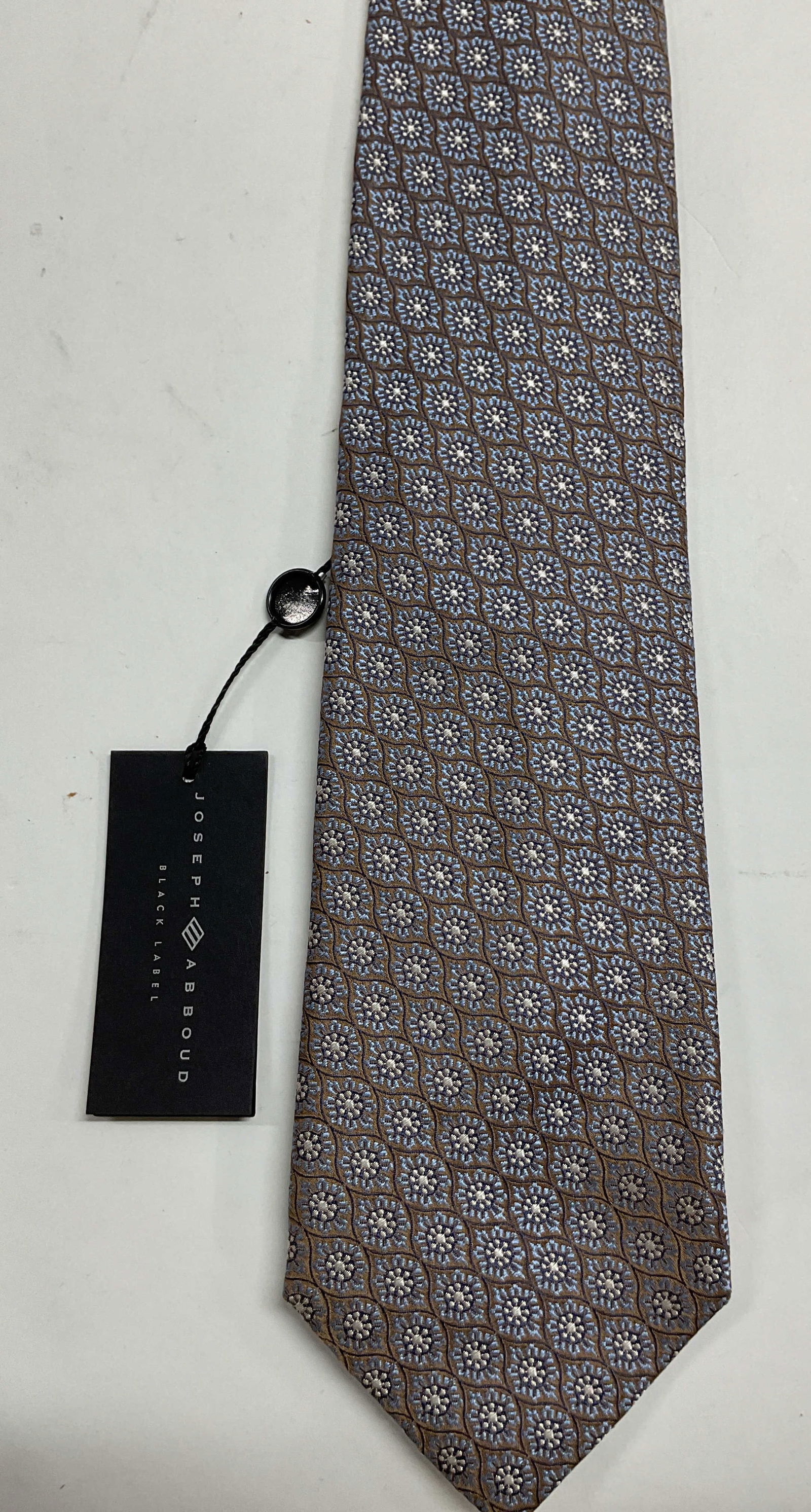 Joseph Abboud Silk Neck Tie Italy NWT: New with tag. Joseph Abboud silk neck tie. Hand made in Italy. 100% silk. Floral motif pattern in grey, white, and blue. Measures approx 4 x 55 inches. Tie, neck tie, silk tie, Joseph Abboud,