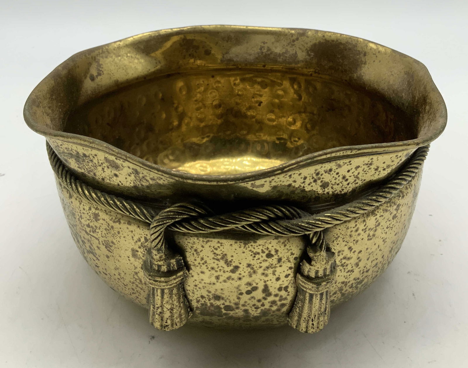 Vtg Hammered Brass Vessel W Tassel Accents: Vintage hammered brass vessel, featuring a scalloped edge & rope detailing with tassels. No visible signature or markings. Surface wear consistent to age, use & exposure. Measurements: length