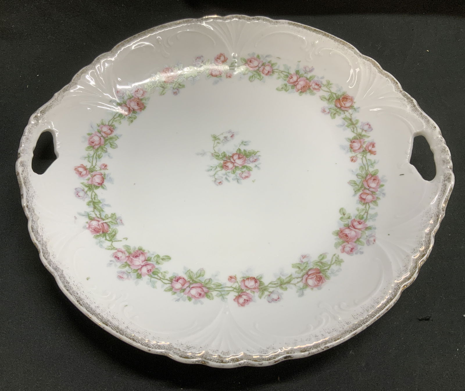 Vtg Pink Floral Porcelain Handled Plate: Vintage porcelain handled plate features pink floral motifs with green leaves. Glossy finish & scalloped edge. Faded gilt accents. No visible signature or markings. Surface wear consistent to