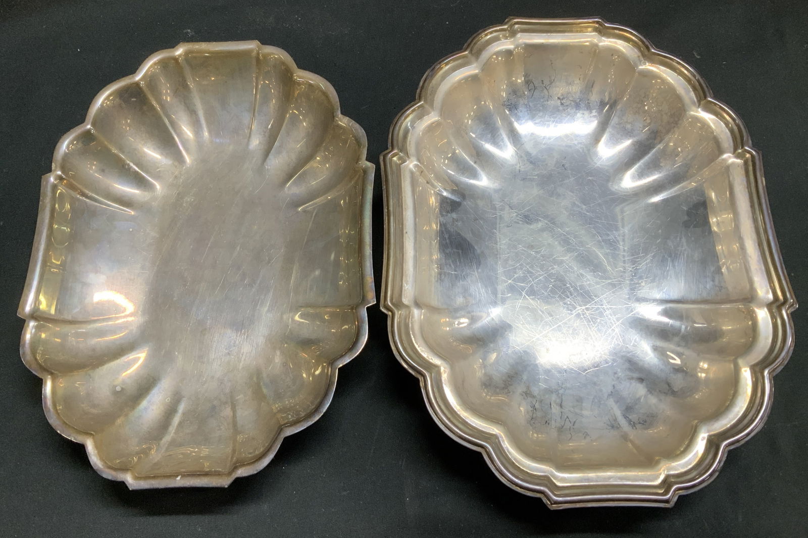 Lot 2 Vtg Silver Plated Scalloped Dish NEWPORT+: Lot includes, 2 Vintage silver plated dishes featuring a scalloped edge. Vary in size. Signed & marked on underside. Reads, NEWPORT SILVER PLATE. Surface wear consistent to age, use & exposure.