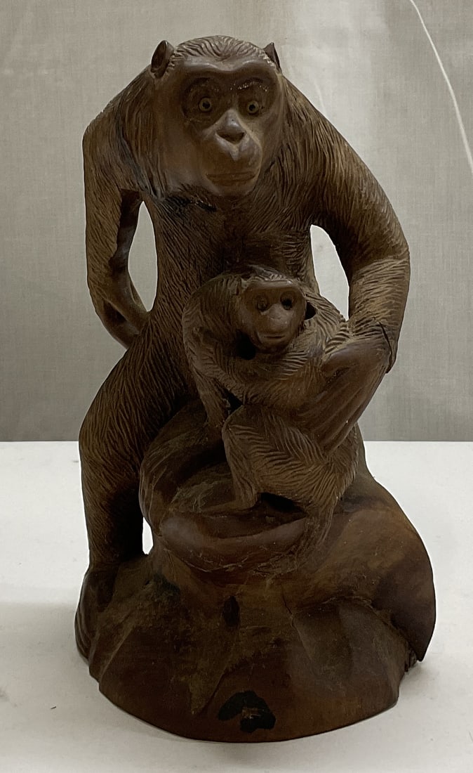Carved Monkey Okimono Figural: Carved Monkey Okimono from Japan featuring a mother monkey with her baby. Intricately carved from wood. Measures approximately 4 and 11/16 x 8 inches. Some cracks in the wood consistent with age. Carv