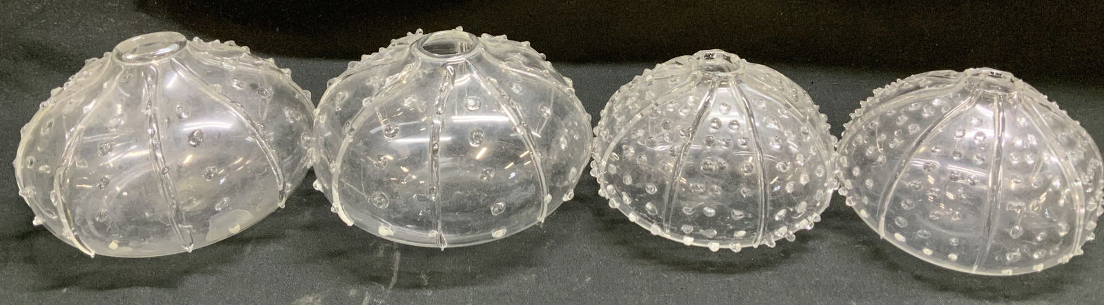 Lot 4 Hand Blown Glass Urchin Bud Vases: Lot includes, 4 hand blown glass bud vases featuring a textured body & round body. Different sizes. Sold as is. Surface wear consistent to age, use & exposure. Measurements: length 3.3in x width 3.3in