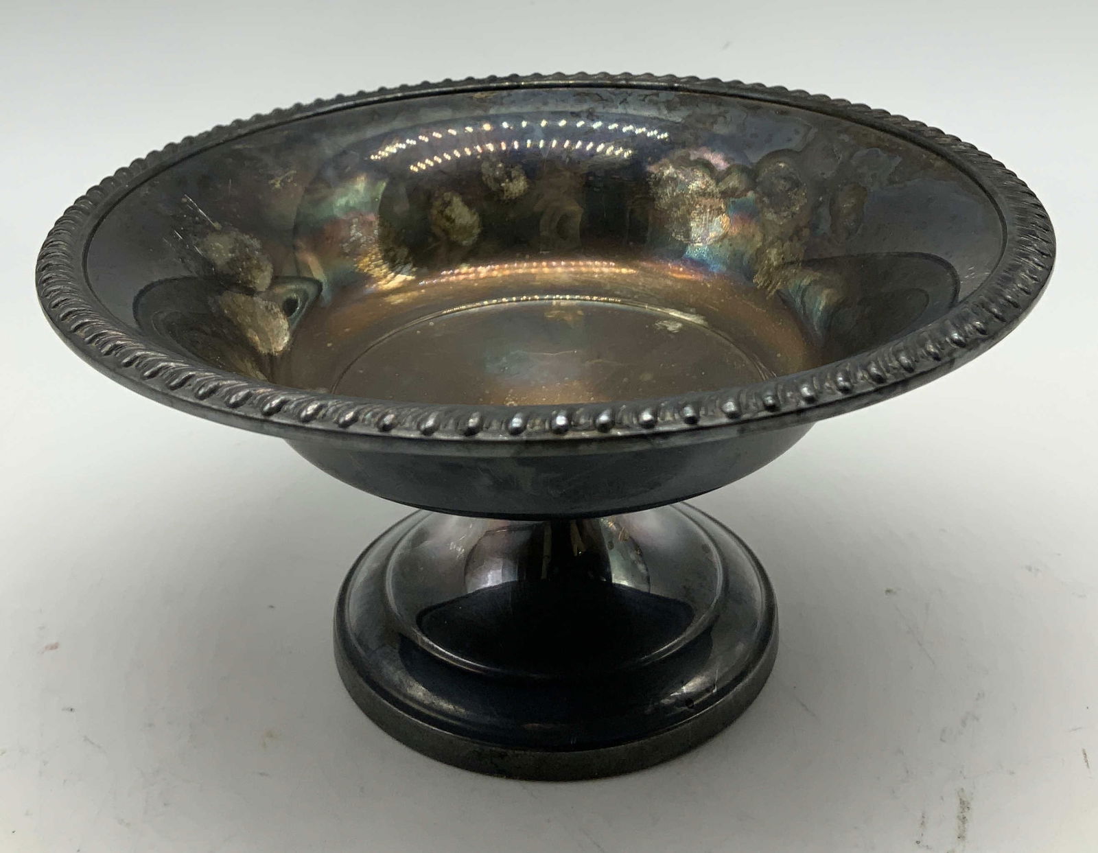 Vtg Art S Co. Silver Plated Footed Compote: Vintage Art S Co. S.P.C. silver-plated round footed compote features a decorative rim. Signed & marked on underside. Reads, ART S CO. S.P.C. 96. Surface wear consistent to age, use & exposure. Measure