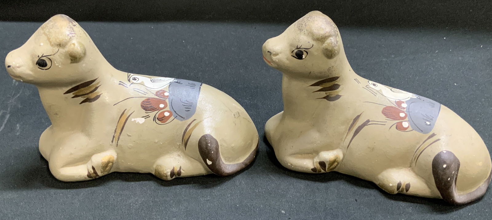Lot 2 Vtg Hand Painted Ceramic Cow Figs: Lot includes, 2 Vintage ceramic cow figurines featuring a hand painted white bird motif on back. Cows are grey/brown toned. No visible signature or markings. Surface wear consistent to age, use &