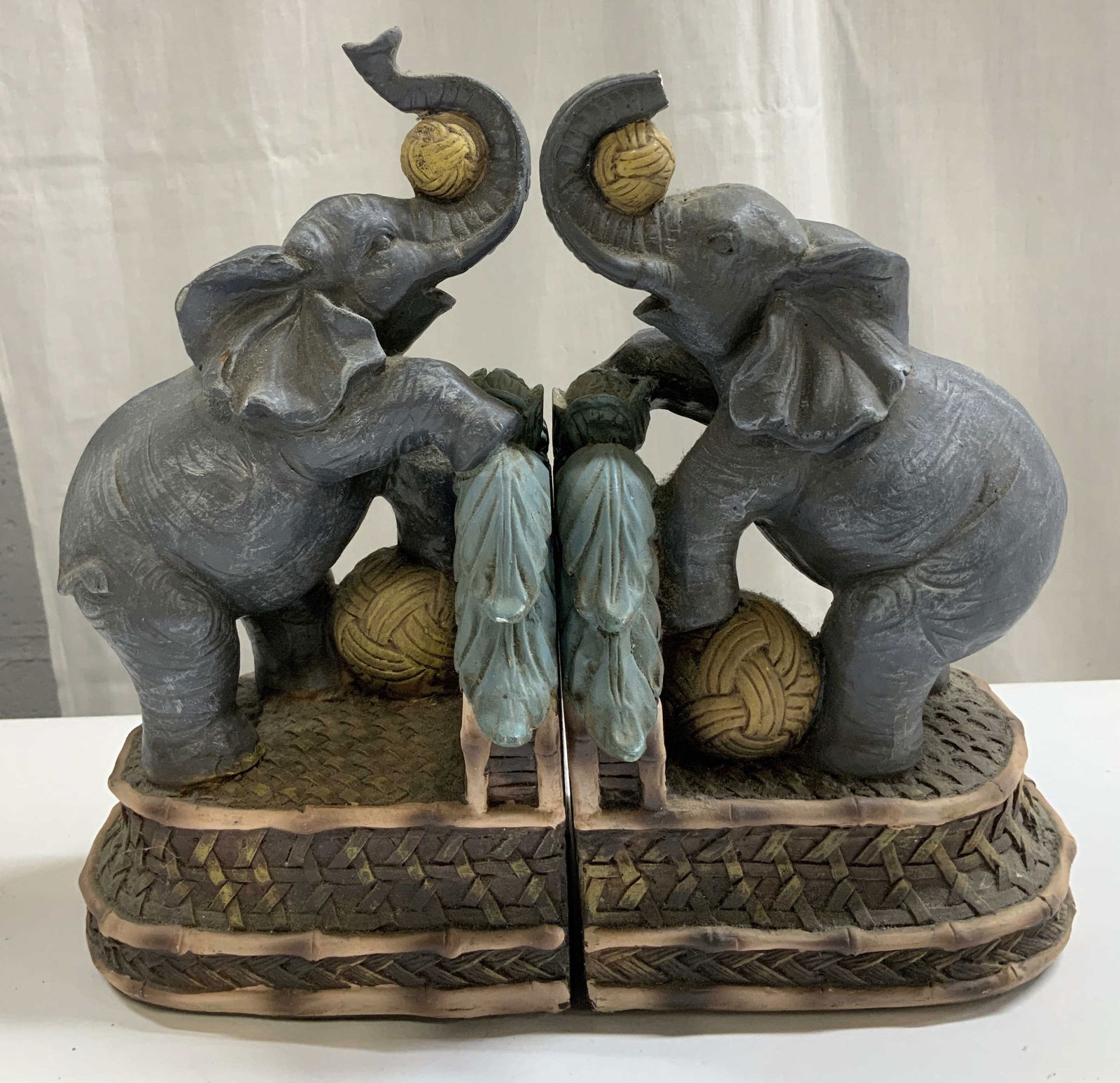 Pair Vtg Melannco Elephant Bookends: Lot includes, a pair of vintage Melannco bookends depicting 2 gray elephants holding balls with their trunks. Textured detailing. Appears to be possible resin material. Signed & marked on underside. R