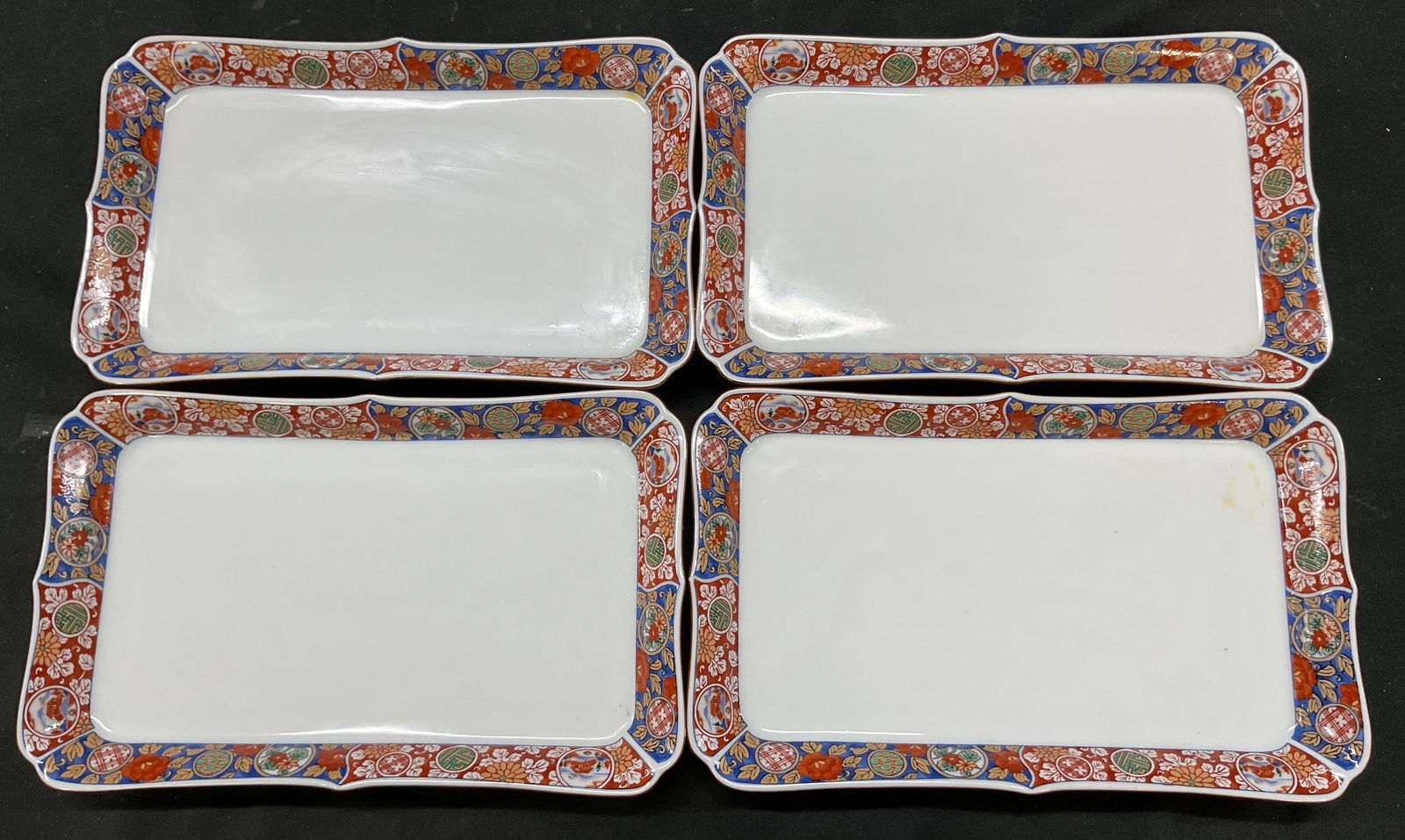 Set 4 Vtg Japanese Porcelain Trinket Tray: Set of 4 vintage Japanese porcelain trinket trays. Signed with Japanese characters on underside. Scalloped edges. Hand painted motifs on flowers, leaves, and architecture. Hand painted blue floral mot