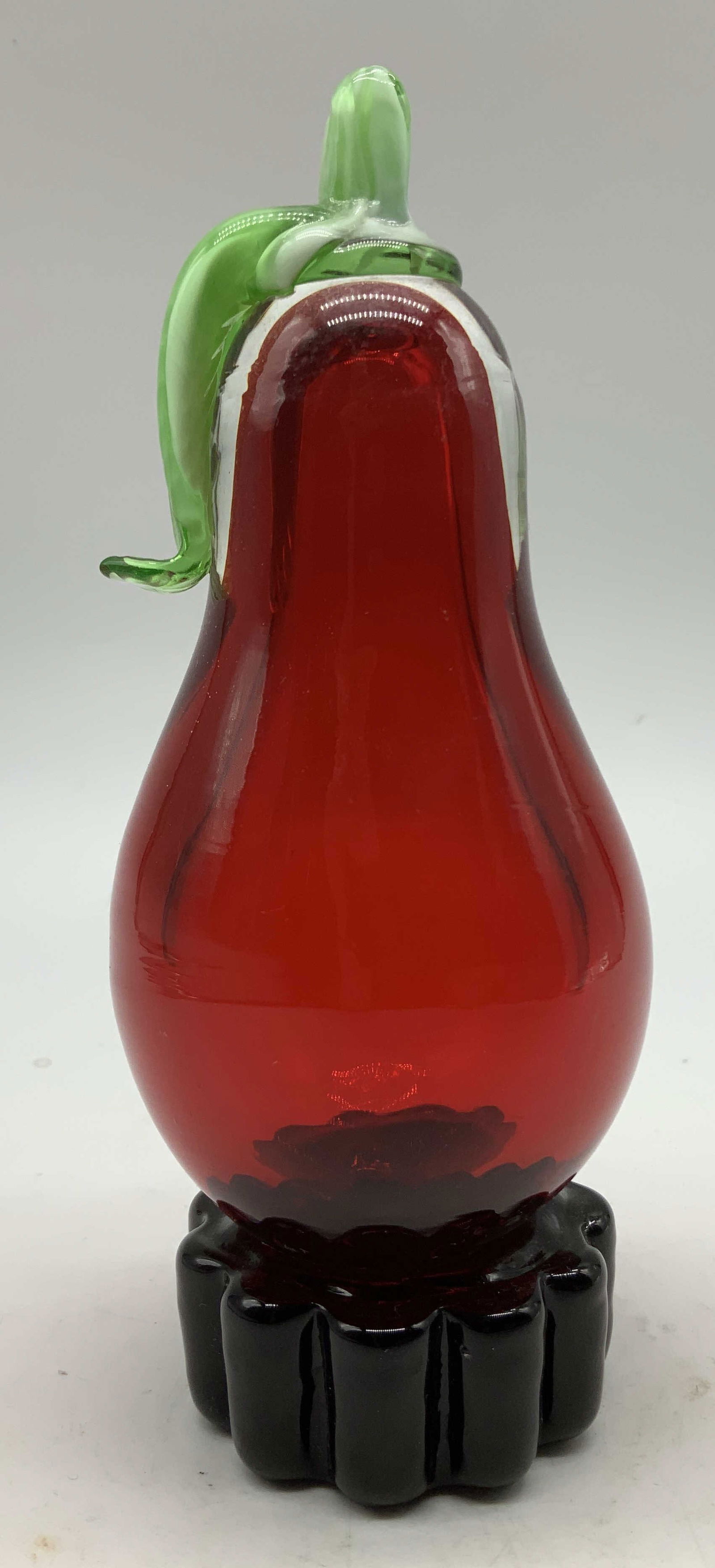 Hand Blown Art Glass Pear Figurine: Hand blown art glass pear figurine featuring a rich red body & green glass stem. Base has a scalloped finish. Surface wear consistent to age, use & exposure. No visible signature or markings. Measurem