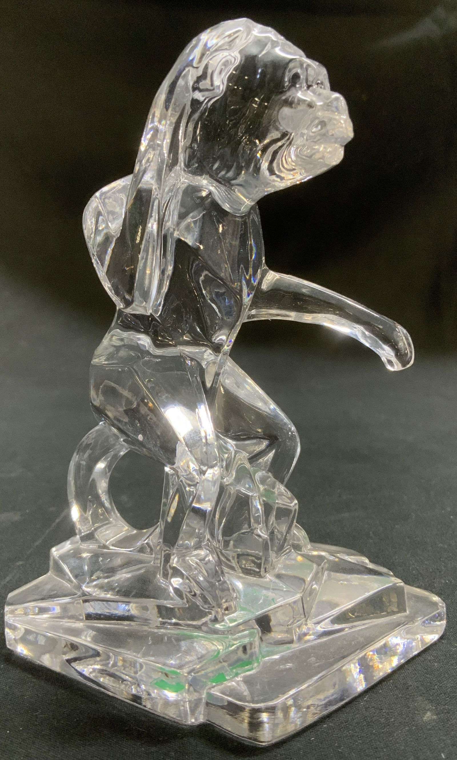 Kristal Color Crystal Monkey Figurine ITALY: Kristal Color clear monkey figurine sitting on a base & one arm towards its ear. Signed & marked. Reads, KRISTAL COLOR. MADE IN ITALY. 24% PBO. Surface wear consistent to age, use & exposure. Measurem