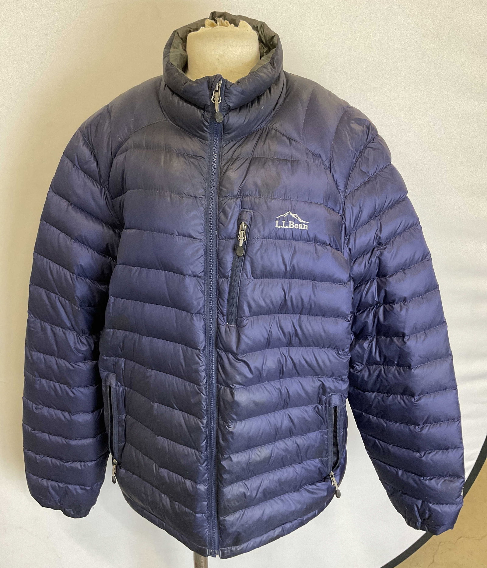 L.L. Bean Blue Zipper Puffer Quilt Jacket: L.L. Bean blue zipper puffer quilt jacket. Nylon material. Embroidered L.L. Bean logo. Collared jacket. Front pockets with zippers. Zipper top to bottom. Inside tag with information as photographed he