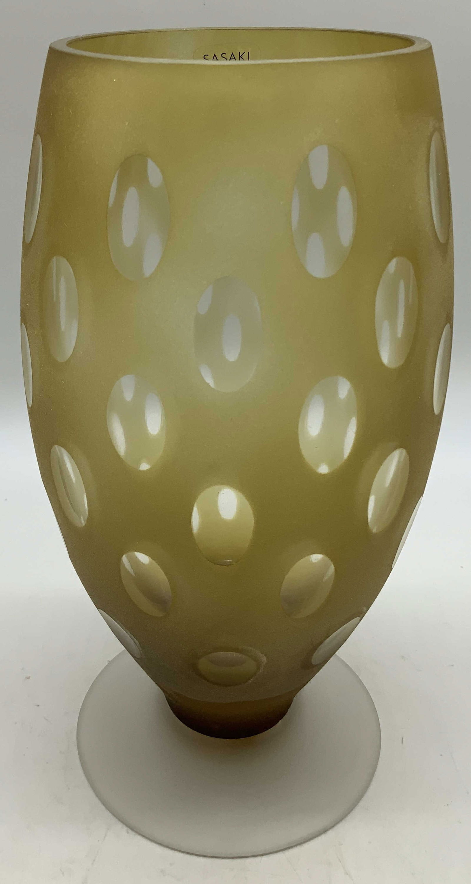 Sasaki Handcrafted Crystal Amber Vase: Sasaki handcrafted crystal vase features circular patterns on body. Footed base. Amber toned. Signed & marked. Reads, SASAKI CRYSTAL HANDCRAFTED. Surface wear consistent to age, use & exposure. Measur