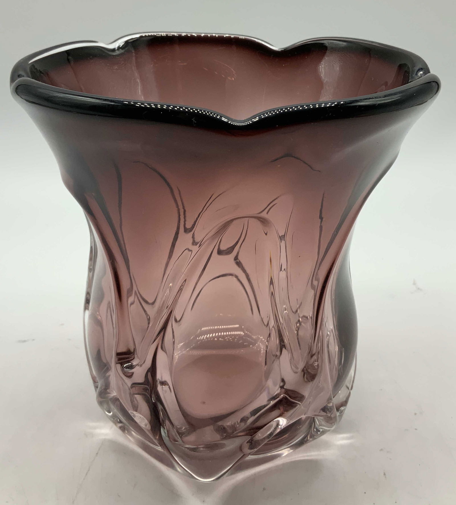 MCM Purple Art Glass Vase: Art glass vase features a distinctive form on body & scalloped rim. Purple toned. Mid century modern style. No visible signature or markings. Surface wear consistent to age, use & exposure. Measuremen