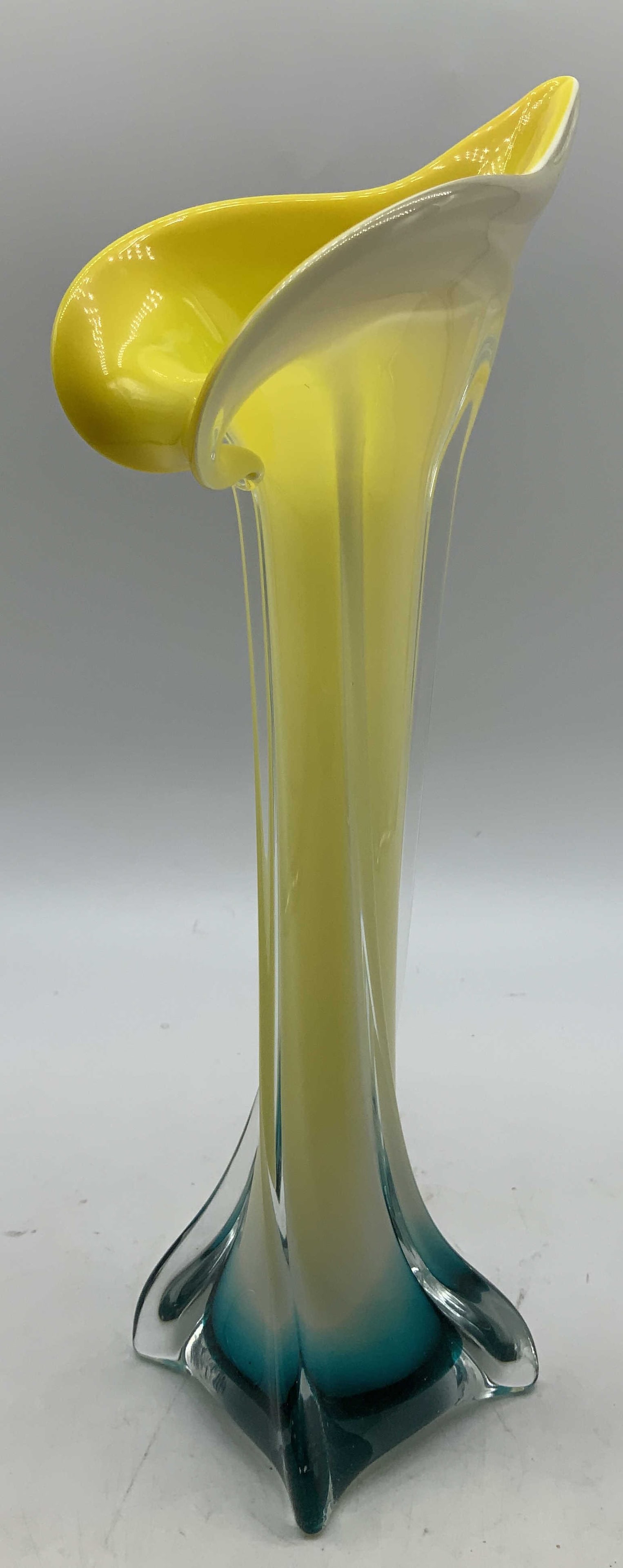 Yellow & Blue Jack In Pulpit Art Glass Vase: Art glass vase features a Jack in the Pulpit style. Asymmetrical flared rim. Yellow, blue & white toned. Surface wear consistent to age, use & exposure. Measurements: length of base 2.7in x width