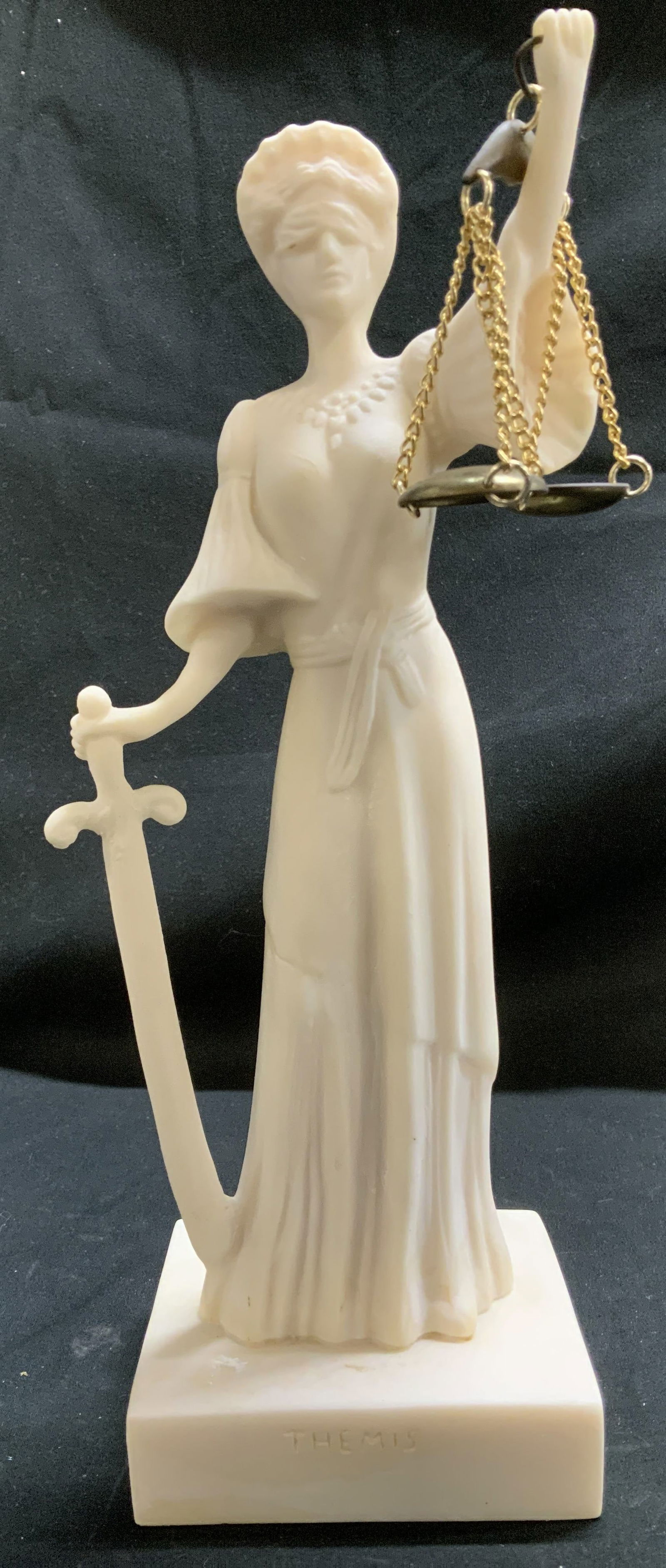 Ifestos Hand Made Alabaster Themis Figurine: Themis lady figurine is holding a sword in one hand & gold toned scales in the other. Fig is genuine alabaster material & handmade. Signed & marked on underside. Reads, IFESTOS HAND MADE