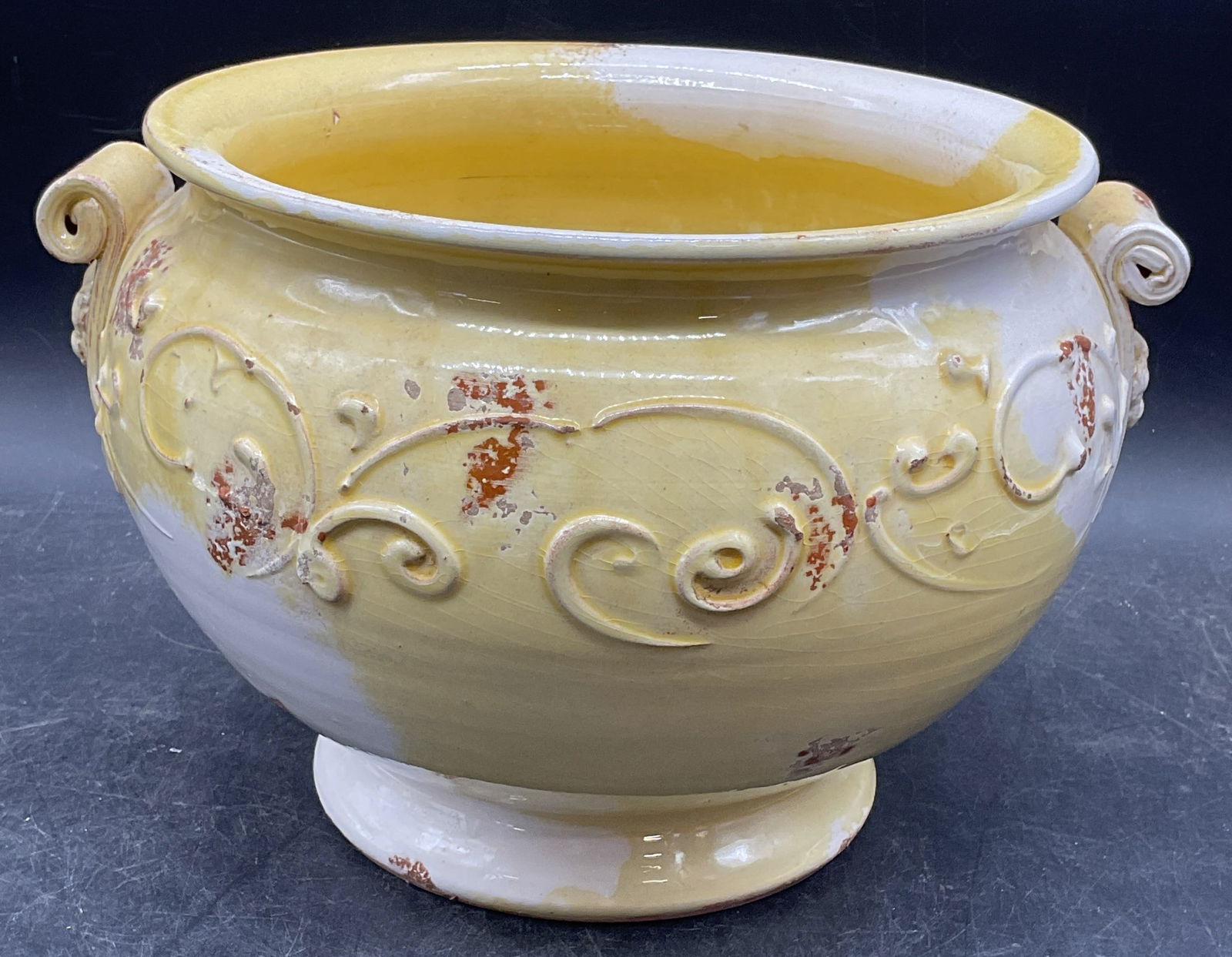 Tuscan Yellow & White Pottery Jardiniere, Italy: Vintage rustic Tuscan terracotta pottery jardiniere. Marked Tuscany, Italy on underside. Hand painted with raised scroll design. Urn shaped with pedestal base. Measures approx 9.5 x 6.5 inches.