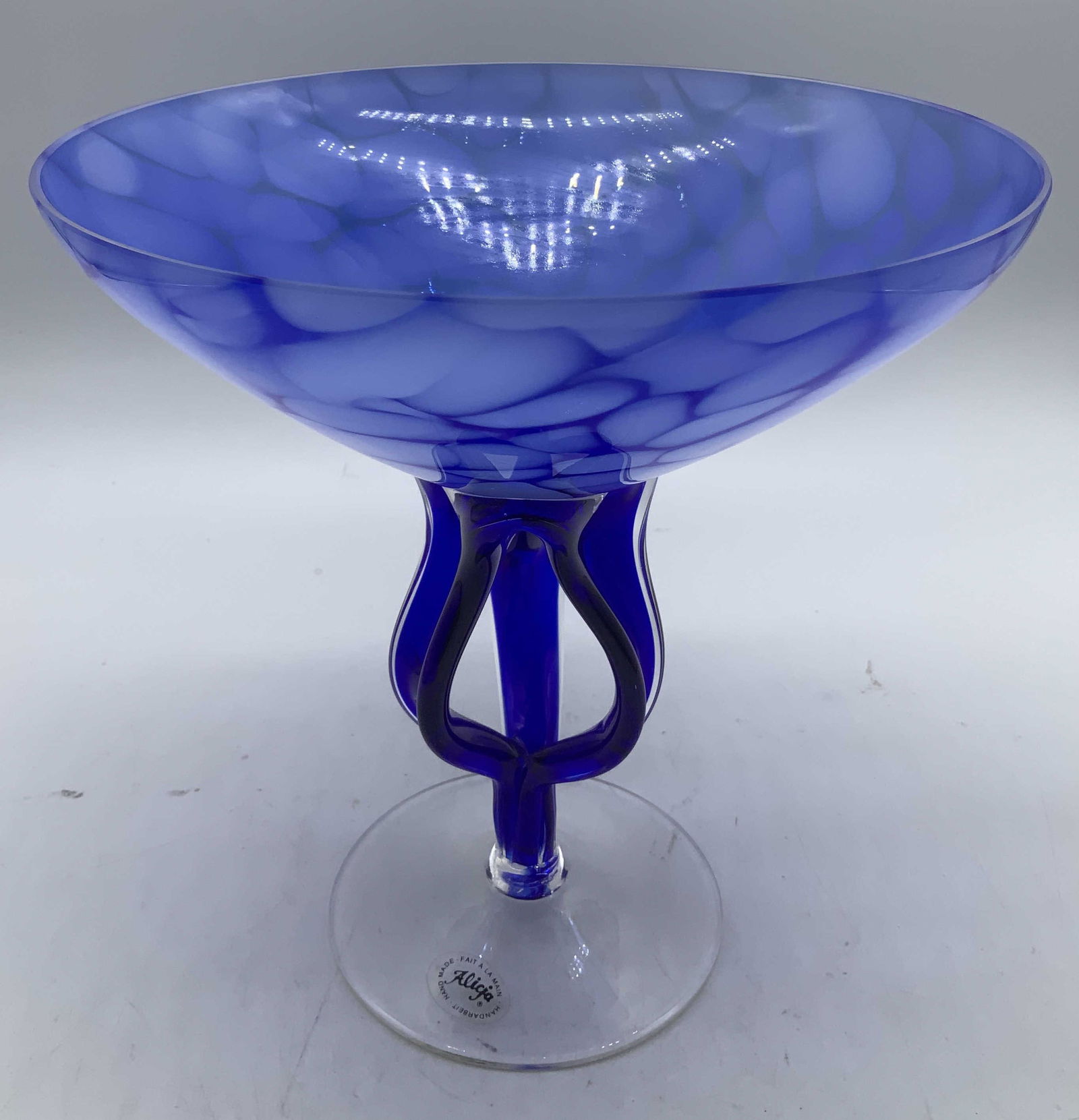 Alicja Hand Made Art Glass Pedestal Bowl: Art glass pedestal bowl features a distinctive jellyfish like design stem. Mottled pattern on bow. Blue & white toned. Round base. Signed & marked. Reads, HAND MADE FAIT A LA MAIN. ALICJA.