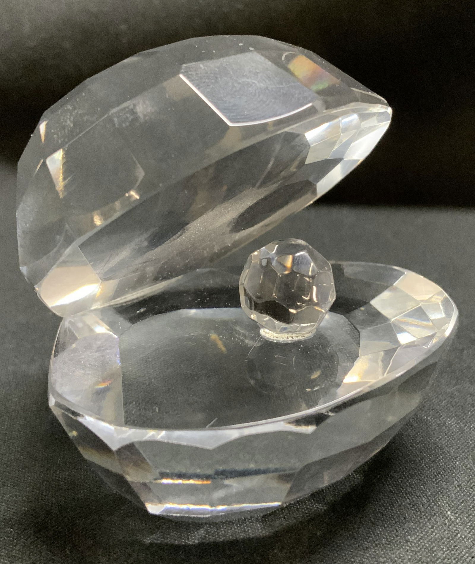 Faceted Crystal Oyster Shell Figurine: Crystal oyster shell figurine features a multifaceted design & small crystal pearl. No visible signature or markings. Surface wear consistent to age, use & exposure. Measurements: length 2.4in x width