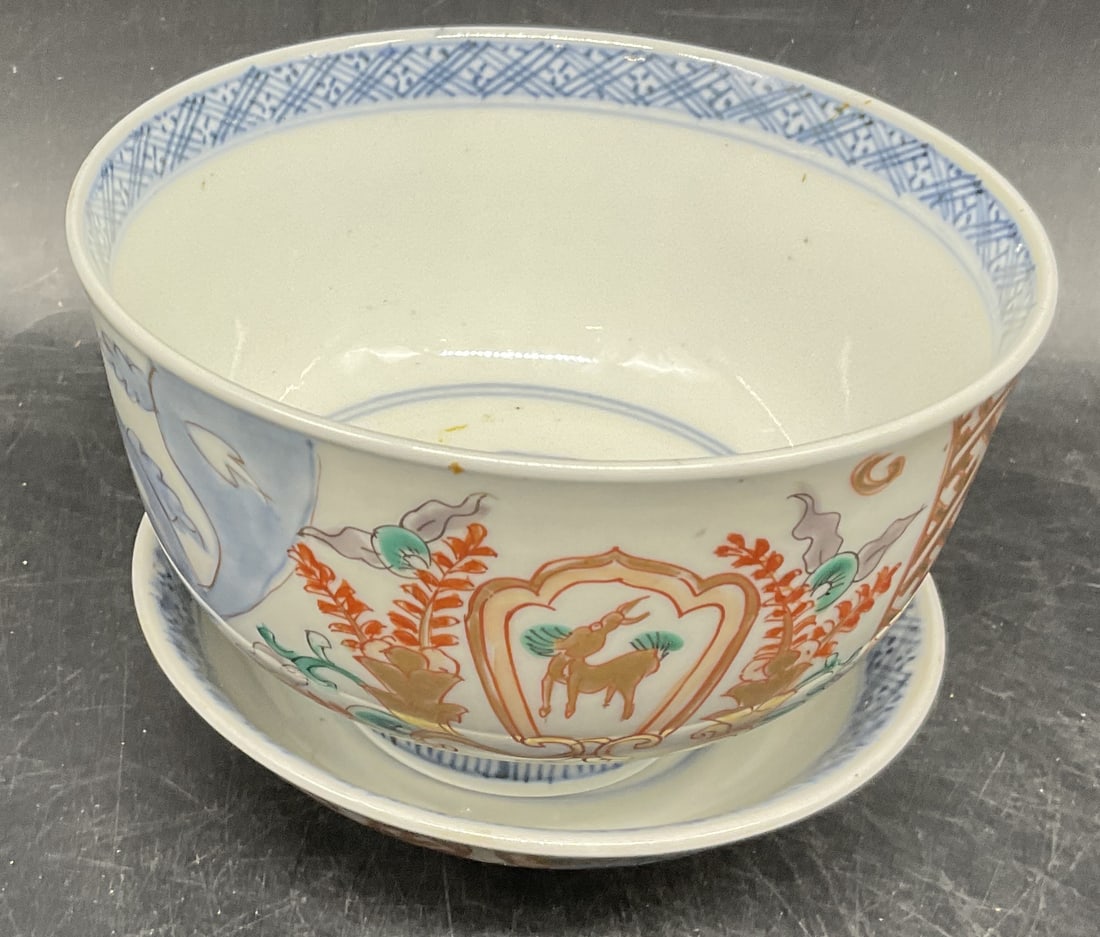 Antique Japanese Porcelain Bowl and Saucer: Antique Japanese Porcelain Bowl and Saucer. Hand-painted in red and gold with a blue underglaze. Made in Japan. Features a blue makers mark on bottom of saucer. Bowl measures approximately 2 3/4in H x