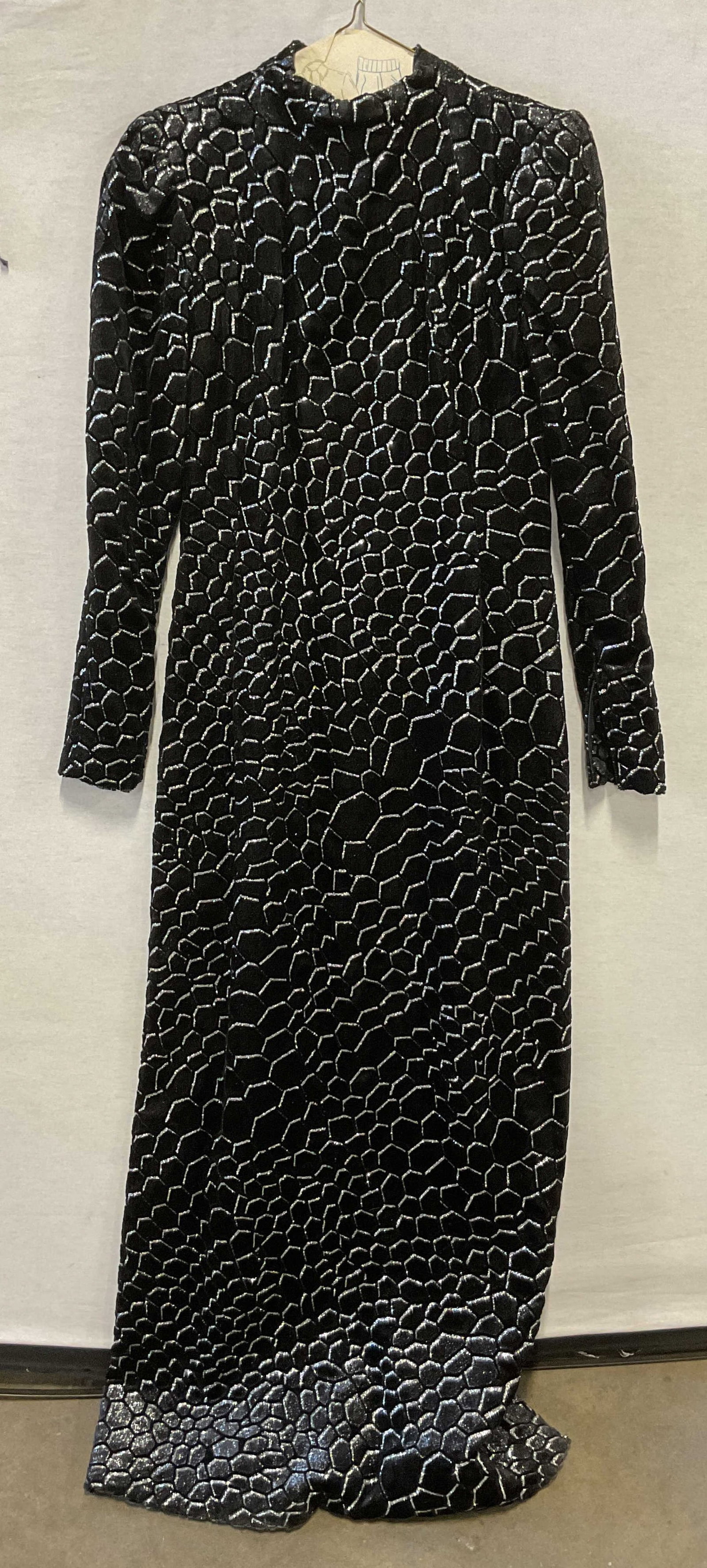 Pauline Trigere Black Sparkly Evening Dress USA: Pauline Trigere black sparkly evening dress. Made in USA. Feels like suede. Geometric pattern with silver toned sparkle accents. Padded shoulders. Split seam design. Back and sleeve zipper. Measures a