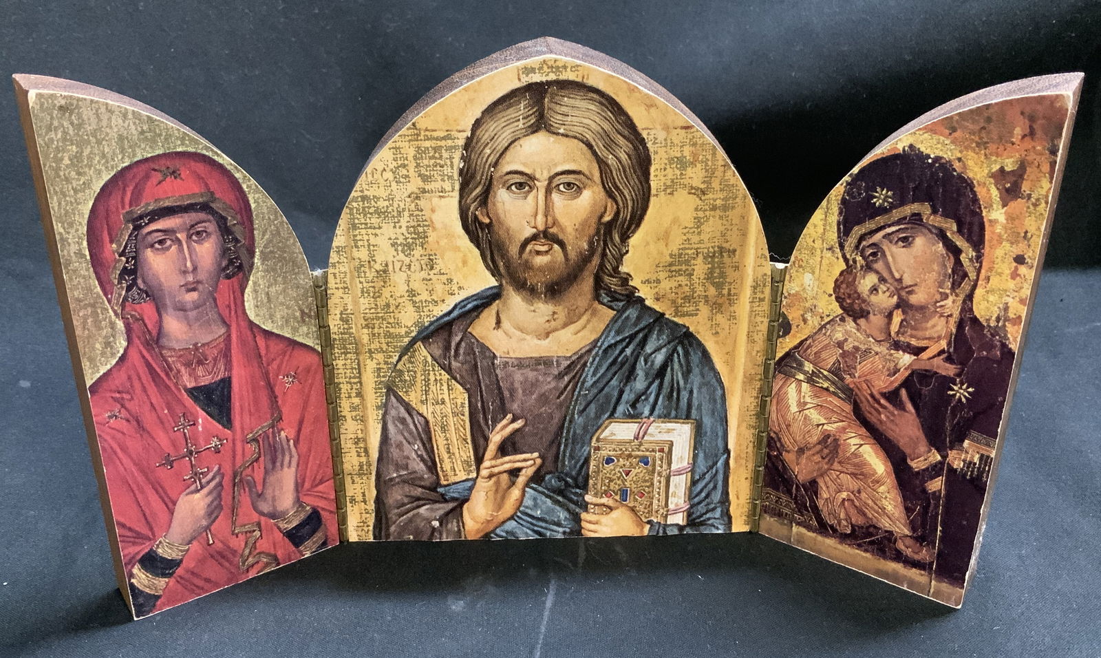 Wooden Triptych Icon, Jesus, Mary & Saint: Folding wooden triptych icon featuring a central image of Jesus & side panels with Virgin Mary & Saint. Printed on. No visible signature or markings. Surface wear consistent to age, use &