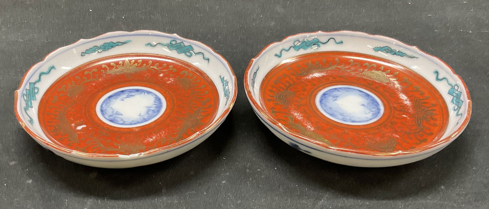 Pair Japanese Imari Porcelain Dishes: Lot of 2 Japanese Imari Porcelain Dishes. Hand-painted in red, gold, and blue underglaze. Marked with red makers marks. Measures approximately 4 3/4 H x 5.5in L. Some wear consistent with