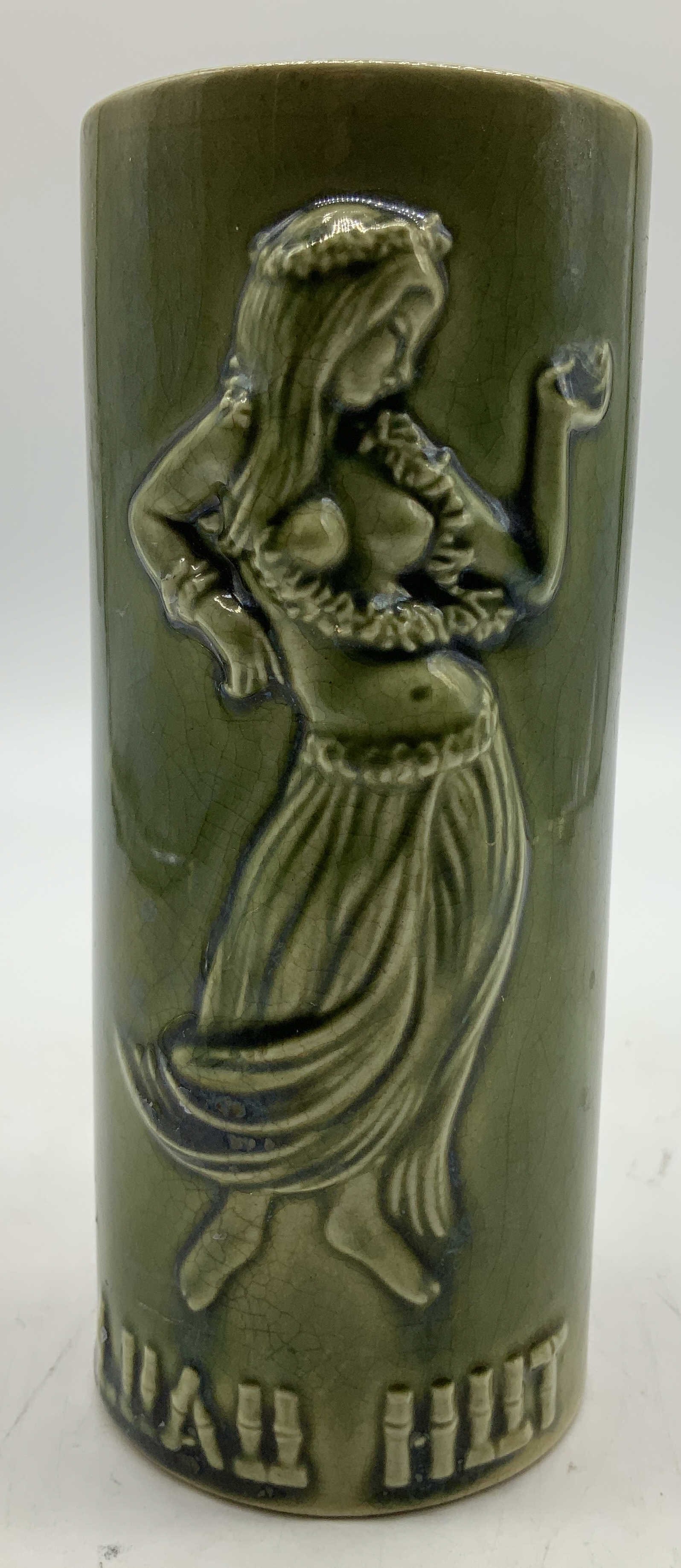 Vtg Luau Hut Souvenir Embossed Vessel: Vintage green glazed ceramic vessel featuring an embossed hula dancer figure. Luau Hut embossed at base. Luau Hut restaurant in Silver Spring, Maryland. Surface wear consistent to age, use & exposure.