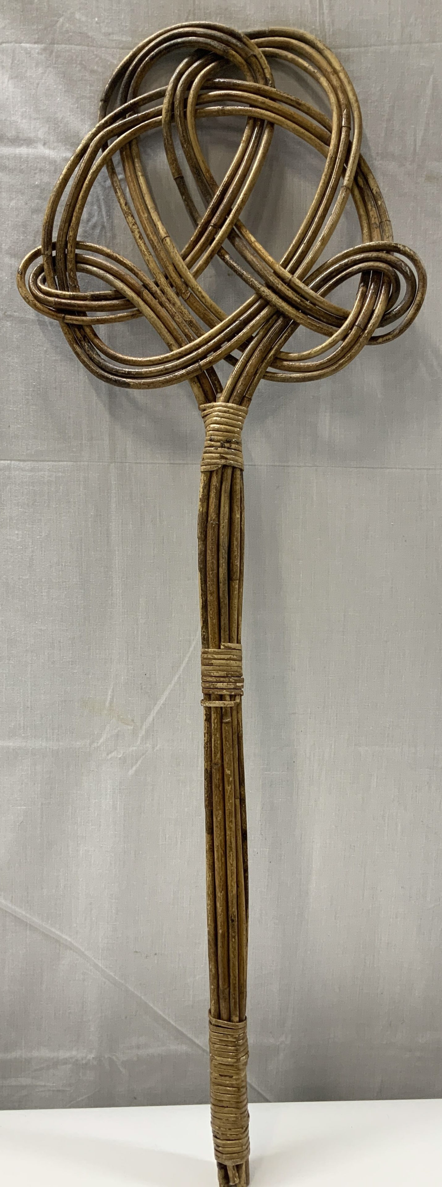 Antique Rattan Rug Beater 30in: Antique, possible vintage. Rattan rug beater features a long, wrapped handle. Head features a loop style design. Surface wear consistent to age, use & exposure. Measurements: Length 10.6in x height 30