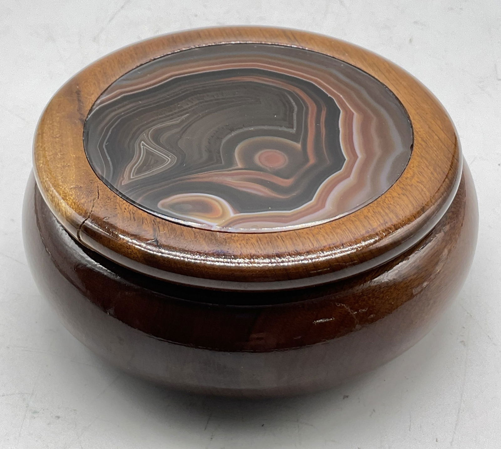 Vtg Wooden Stone Inlay Lidded Trinket Box: Vintage wooden stone inlay lidded trinket box. Round dome shaped wooden box. Stone inlay design on lid in browns and whites. Measures ht approx 2 inches diam approx 4 inches. Surface wear consistent w