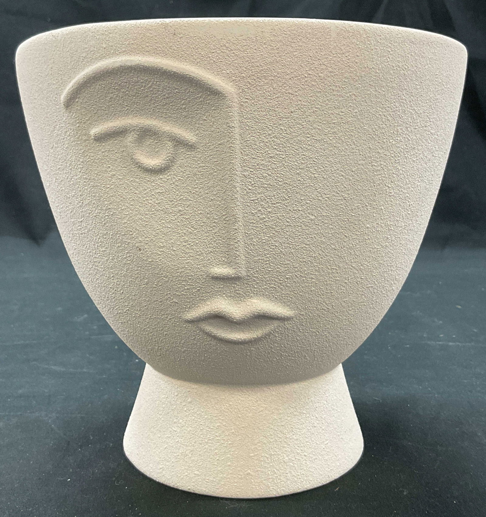 Vintage Ceramic Decorative Face Planter: Vintage ceramic decorative face planter. Round pedestal base. Wide round rim. Embossed motif of half of a face. Measures ht approx 6.5 inches diam approx 7 inches. Surface wear consistent with