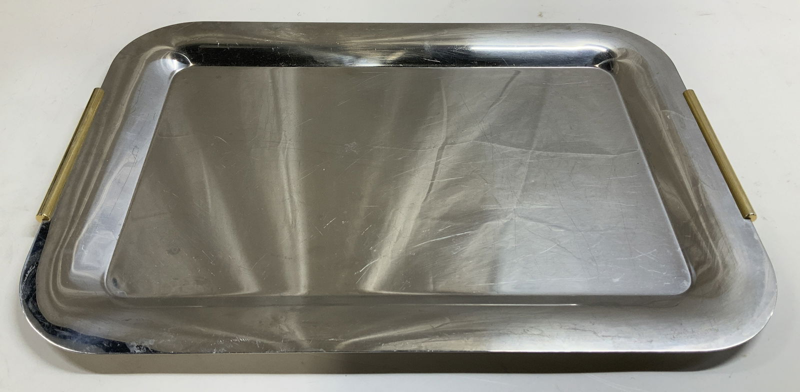 Vtg Rectangular Silver Toned Platter: Vintage silver toned platter features a rectangular shape with gold toned handles. No visible signature or markings. Surface wear consistent to age, use & exposure. Measurements: length 19.5in x