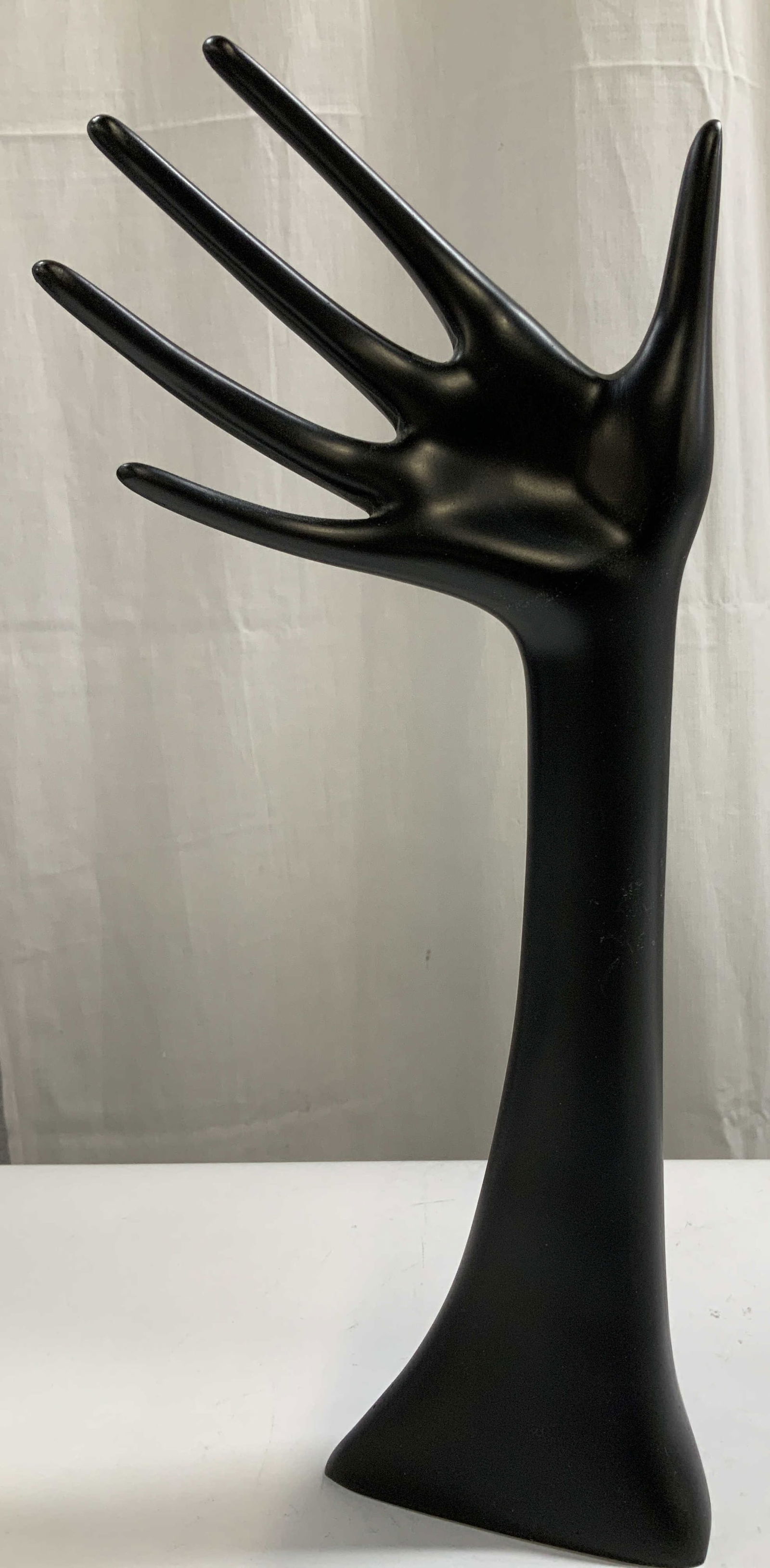 Tiger Stores Jewelry Hand Display 12in: Tiger Stores jewelry hand display is black toned. Appears to be possible composite material. Signed & marked on underside. Reads, TIGER STORES. Surface wear consistent to age, use & exposure.