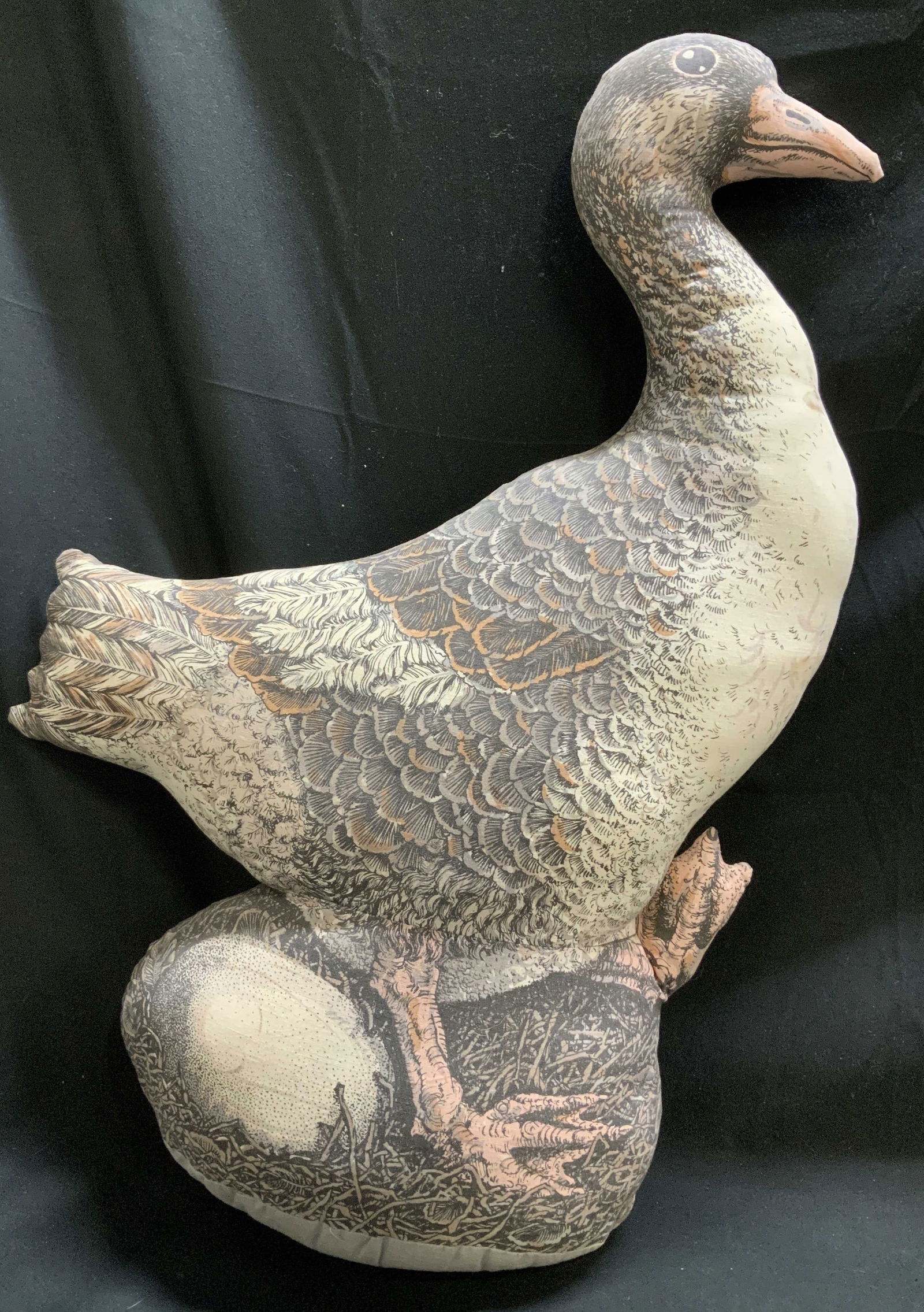 1984 Valerie Leonard The Dancing Goose Plush: Vintage plush depicts a goose with an egg. Shades of brown, orange & cream. Fabric body. Signed & marked on underside. Reads, THE DANCING GOOSE. 1984 THE TOY WORKS; ART. VALERIE LEONARD. Surface