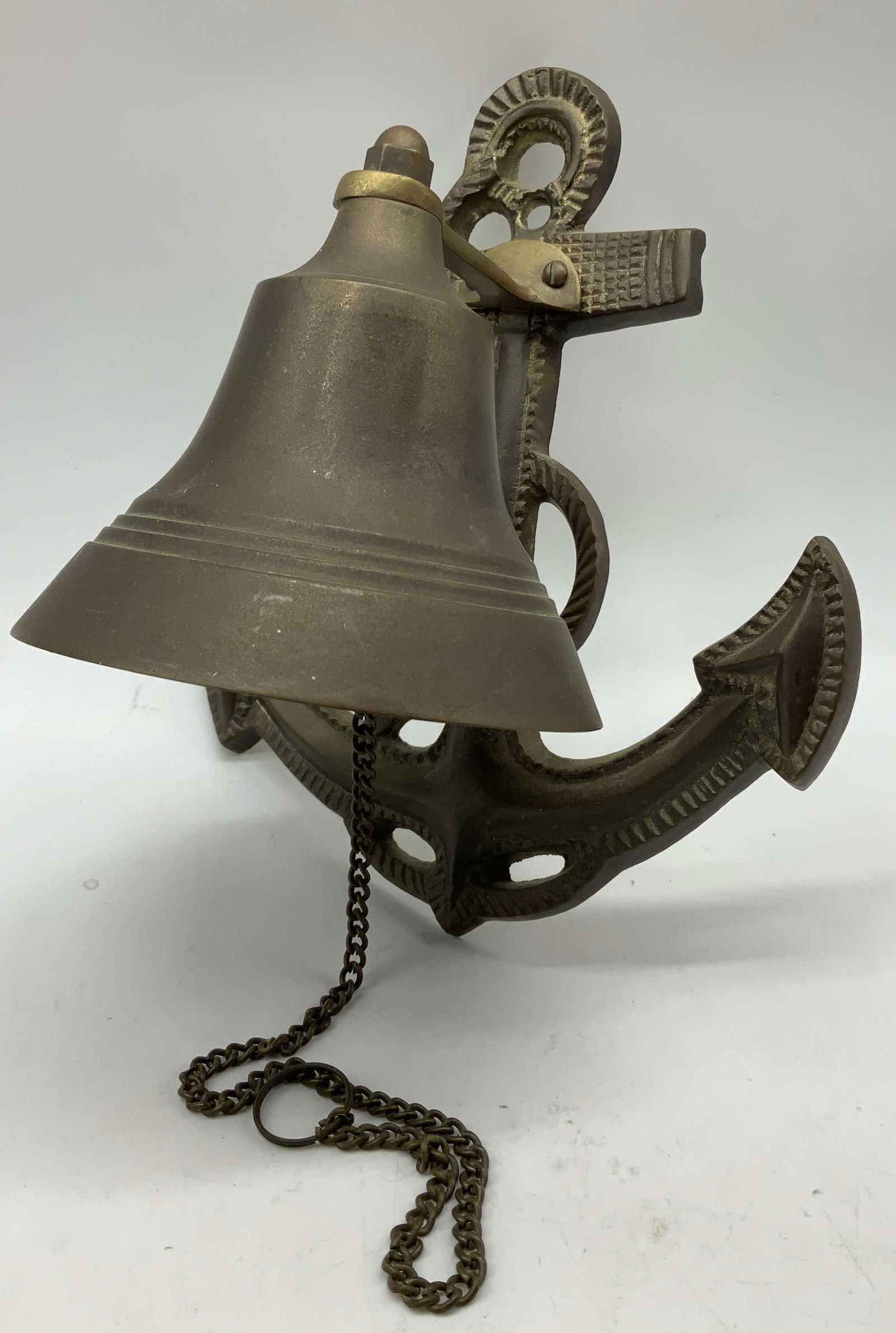 Vtg Brass Nautical Ships Bell Wall Decor INDIA: Vintage brass nautical ships bell mounted on an anchor. Chain is attached. Signed & marked on underside. Reads, MADE IN INDIA. Surface wear consistent to age, use & exposure. Measurements: height 7in
