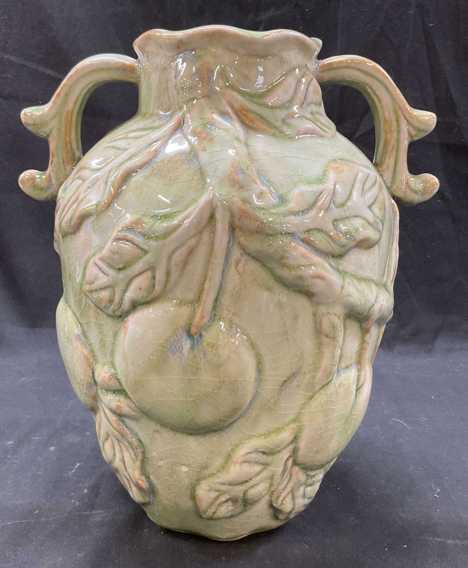 Vtg Ceramic Double Handled Majolica Vase: Vintage ceramic double handled majolica vase. No visible markings. Double handled amphora shape, decorative scroll motifs. Embossed fruit and leaves motifs. Green color with glossy finish. Bulbous bod