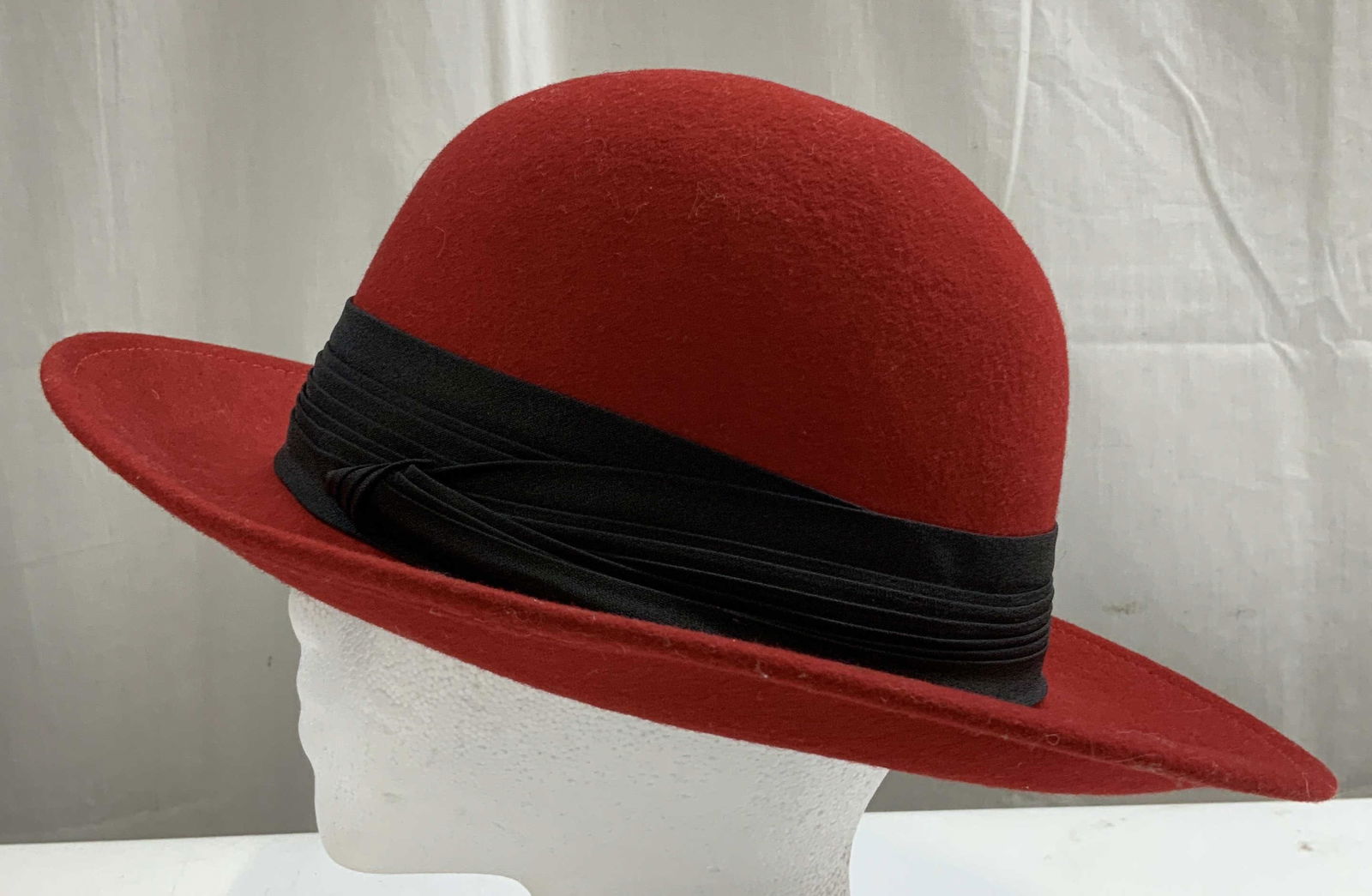 Vtg Lancaster Wool Fedora Hat USA: 100% wool material. Fedora hat is red toned & features a black band. Signed & marked. Reads, LANCASTER. MADE IN USA. Surface wear consistent to age, use & exposure. Measurements: length to brim 12.7in