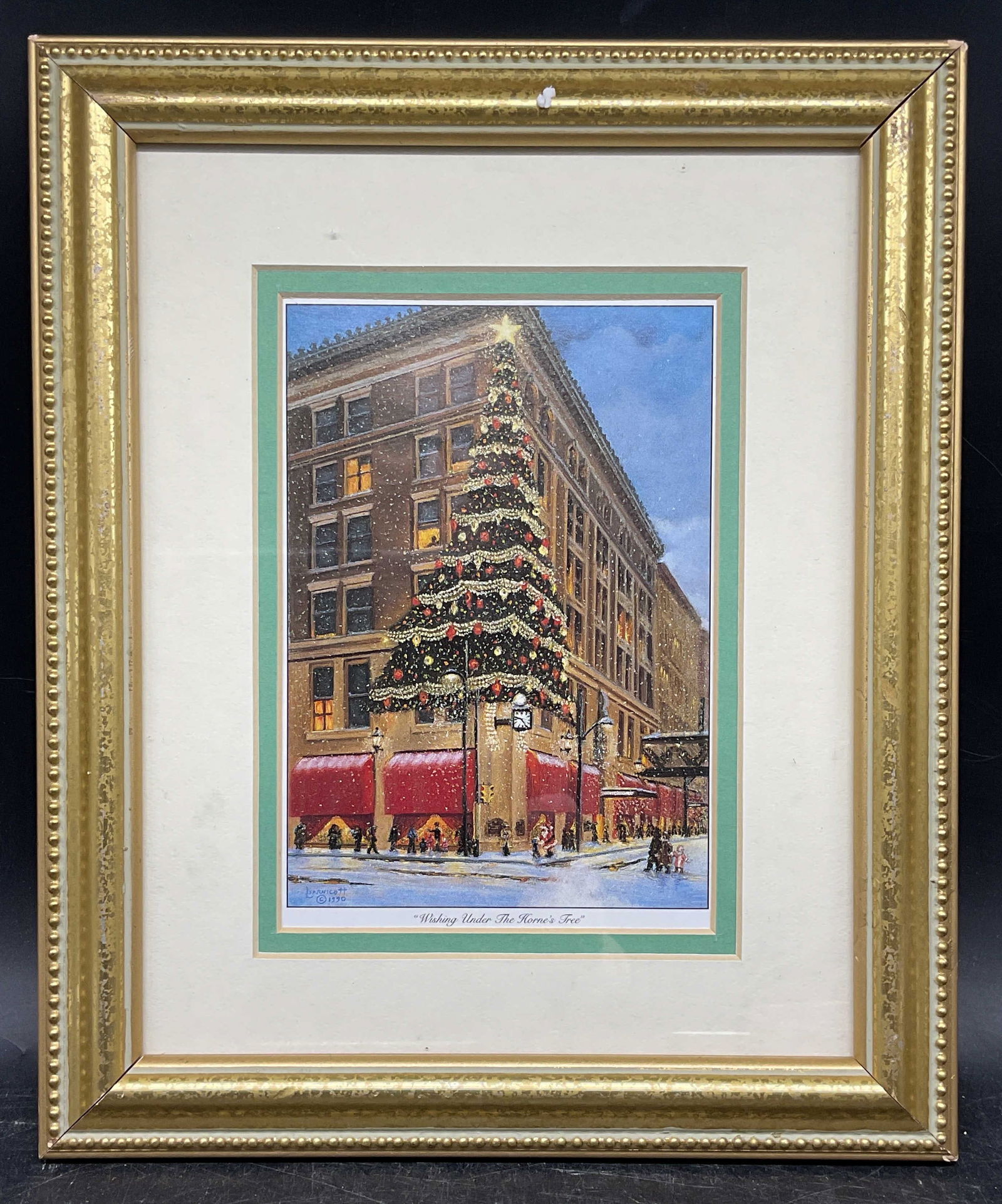 Framed Barnicott Hornes Tree Christmas Litho: Framed and matted lithograph. Linda Barnicott, Wishing Under The Hornes Tree. Christmas tree. Print label on verso from Signature Art Co Gallery Collection. Decorative gilt wood frame. Not examined ou