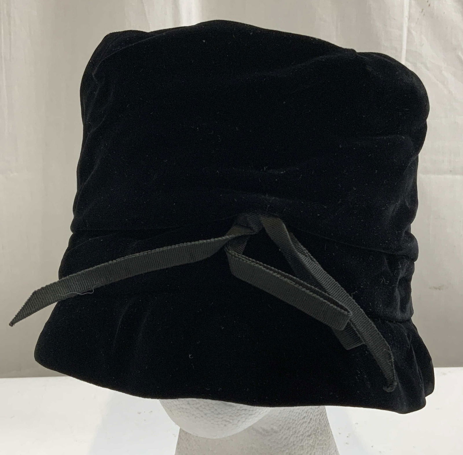 Vtg Noreen Fashion Black Bucket Hat: Vintage black bucket hat features a bow detail at front. Velvet material. Signed & marked. Reads, NOREEN FASHION. Surface wear consistent to age use & exposure. Measurements approximately: length 10in