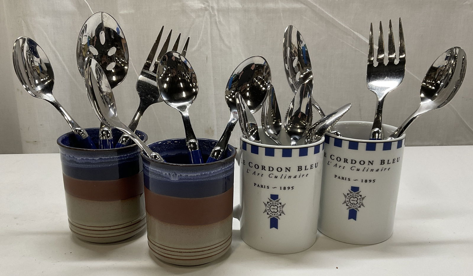 Grp Lt 17 Flatware + Mugs from Mexico, Italy+: Grp Lt 17 Flatware + Mugs from Mexico, Italy, France, and England in a variety of blues. Two blue and brown striped stoneware clay mugs marked Genuine English Kiln Craft Stoneware P.C.O, two ceramic b
