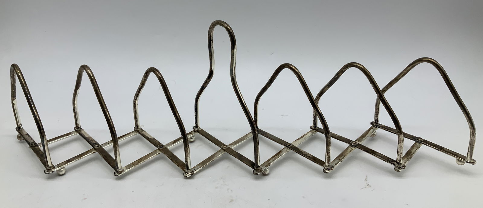 Antq Silver Plated Expandable Toast Rack: Antique, possible vintage. Silver plated toast rack features an expandable design & arched handle for carrying. Sold as is. Surface wear consistent to age, use & exposure. Measurements: length