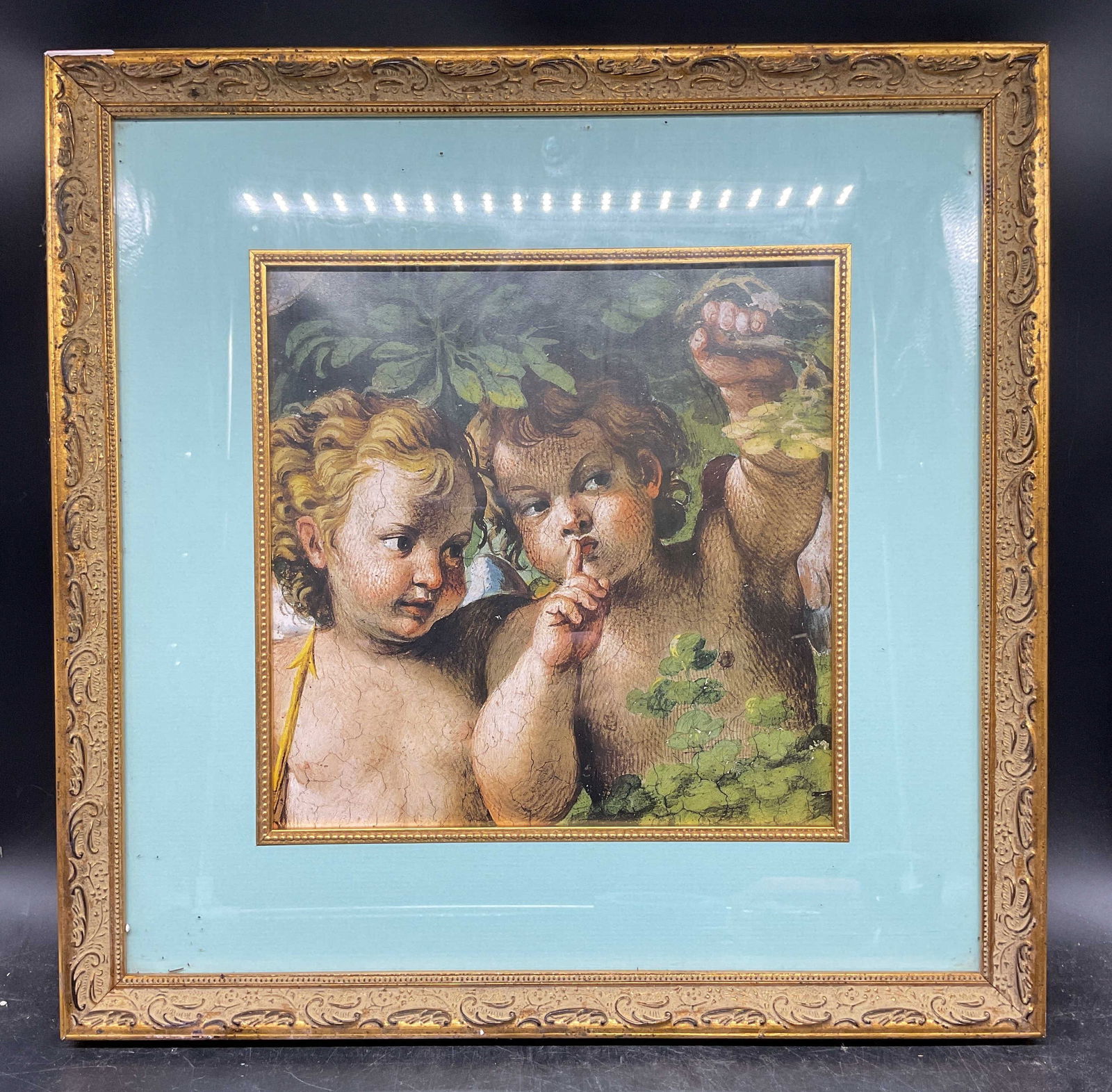 Framed After Caracci Whispering Angel Litho: Framed and matted lithograph. After Annibale Caracci, Whispering Angel. Decorative gilt wood frame. Not examined out of frame. Frame measures approx. 17.25 x 17.25 inches. Wear including scratching. A