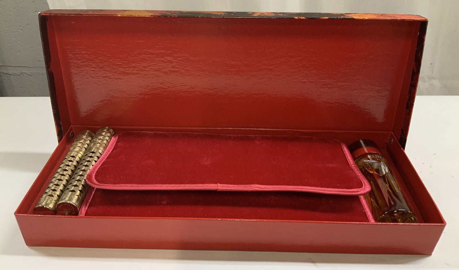 Vtg Faberge Flambeau Jewel Roll,Cologne,Pouch & Bx: Lot includes, 2 Faberge roll on perfume bottles featuring an openwork design. Gilt toned. 1 Flambeau cologne, 1 red velvet pouch & comes with original box. Sold as is. Surface wear consistent to age,