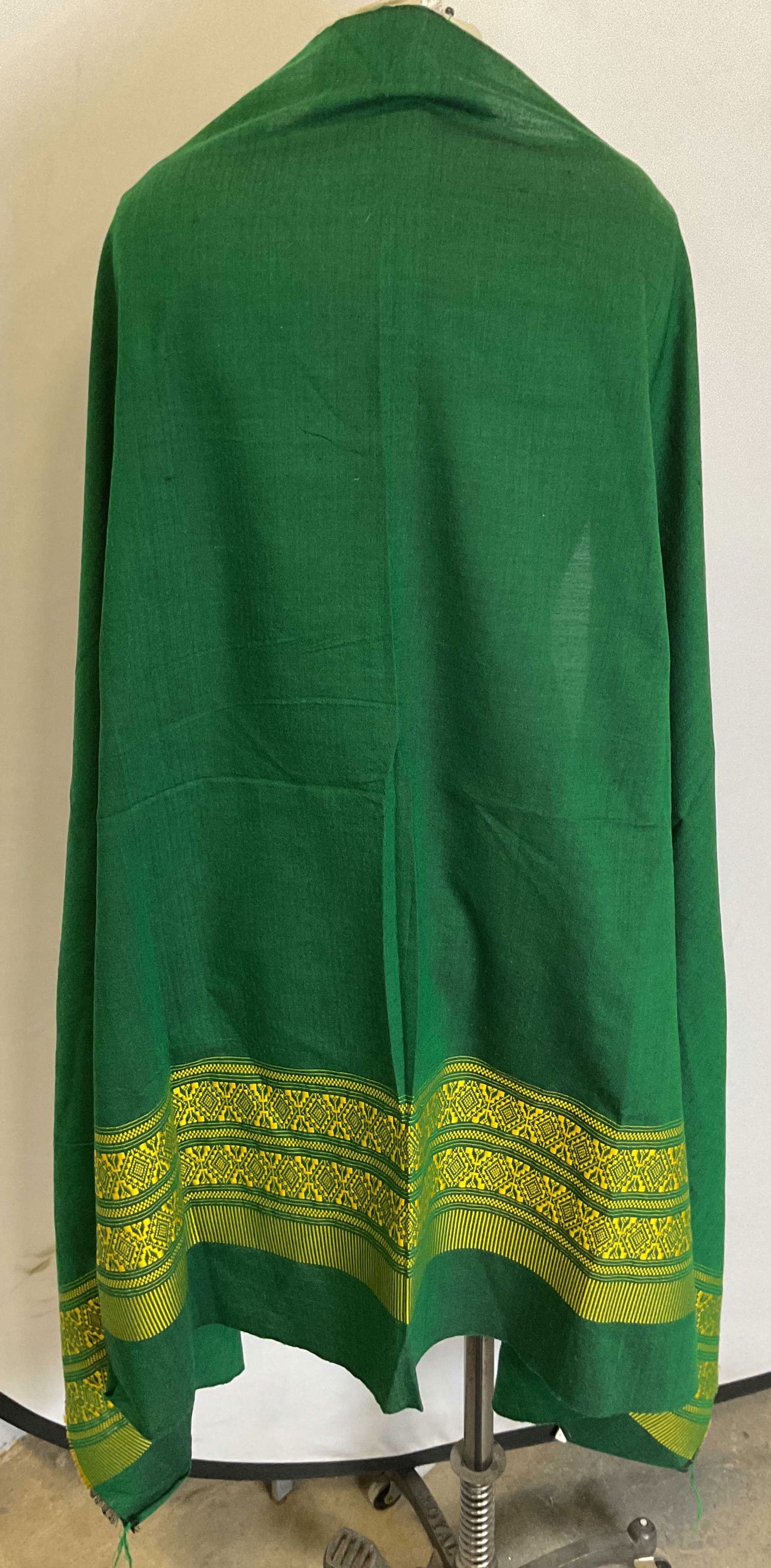Vintage Green Fringed Embroidered Shawl: Vintage green fringed embroidered shawl. Feels like cotton. Fringed trim. Green background with yellow embroidered geometric motifs. Black accents. Measures approx 36 x 58 inches. Some pull to