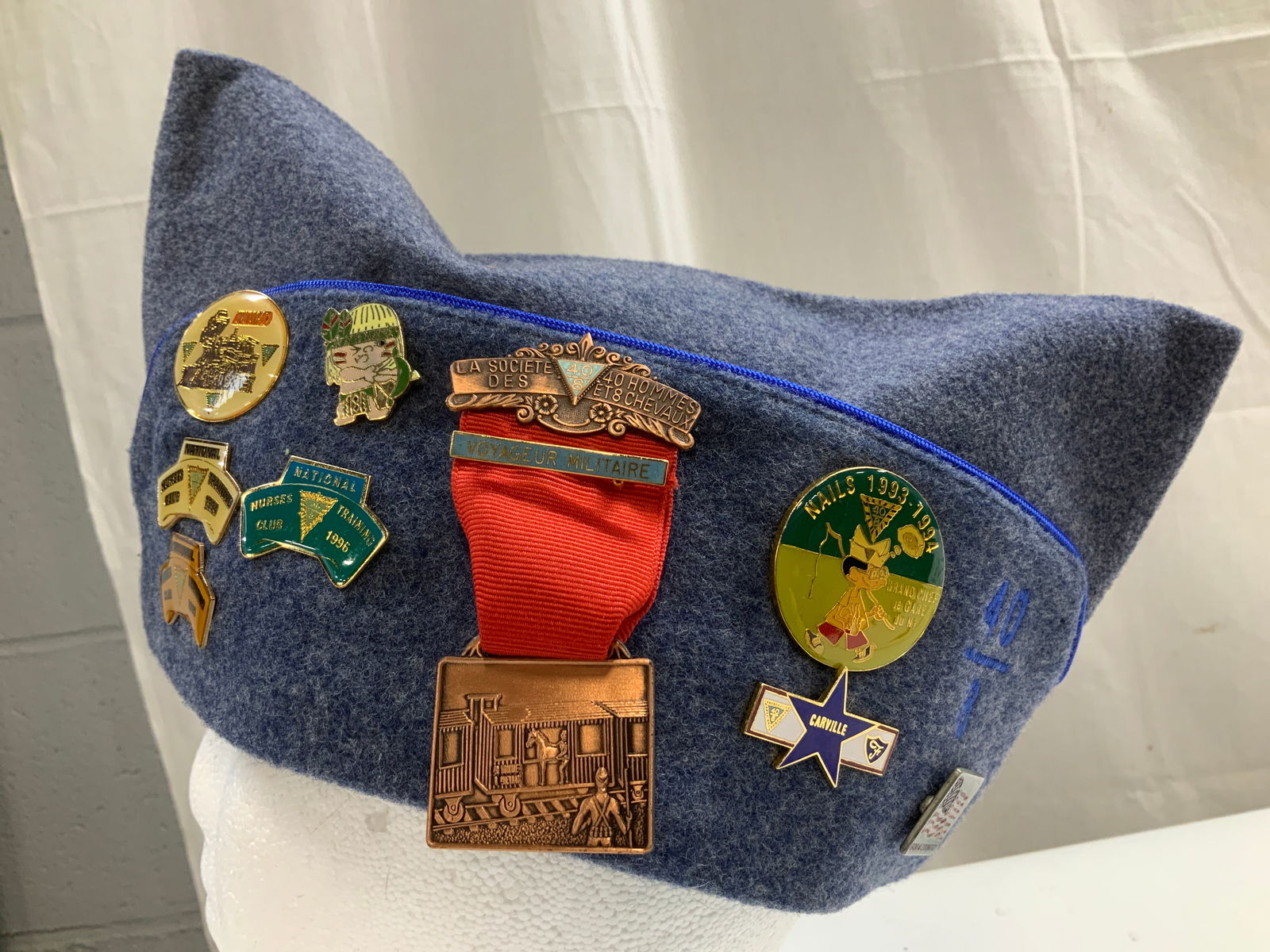 Vtg Dracon Wool Nurse Garrison Cap W Pins U.S.A: Size 7 1/8. 55% Dacron & 45% wool. Made in USA. Garrison cap is navy toned. Features various pins including, AAU/JO, National Nurses Club Training 1994, 1995 & 1996, Carville, La Societe des 40