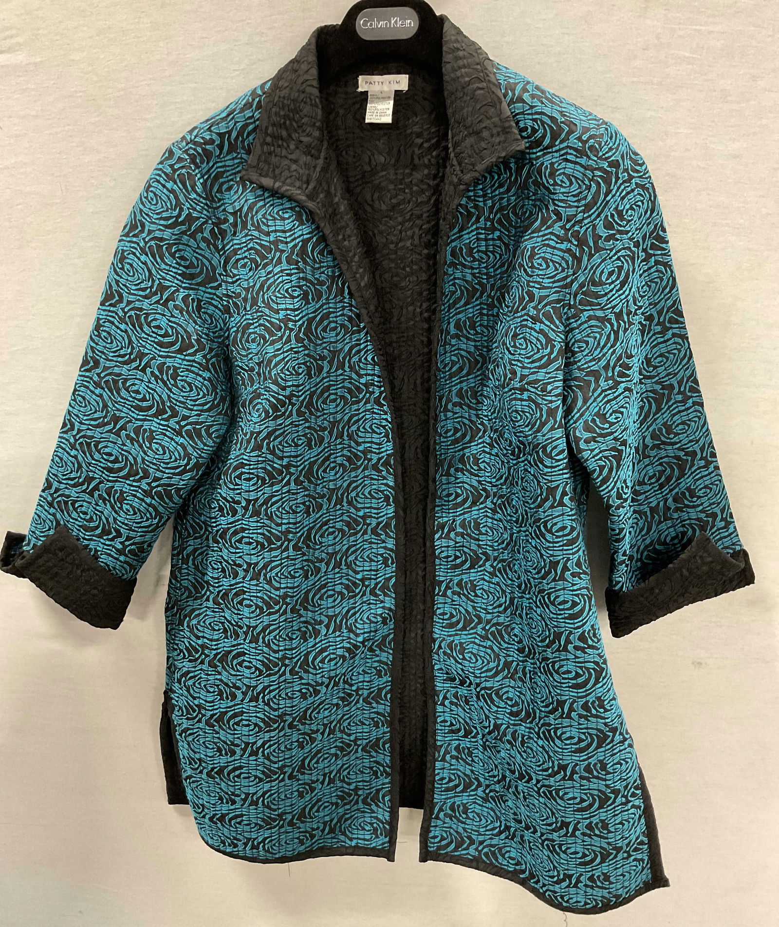 Patty Kim Blue Abstract Cardigan: Patty Kim blue abstract cardigan. Size L. Feels like cotton. Collared. Rolled sleeves and split seam design. Blue abstract pattern. Ribbed surface. Wear consistent with exposure. Cardigan, Patty