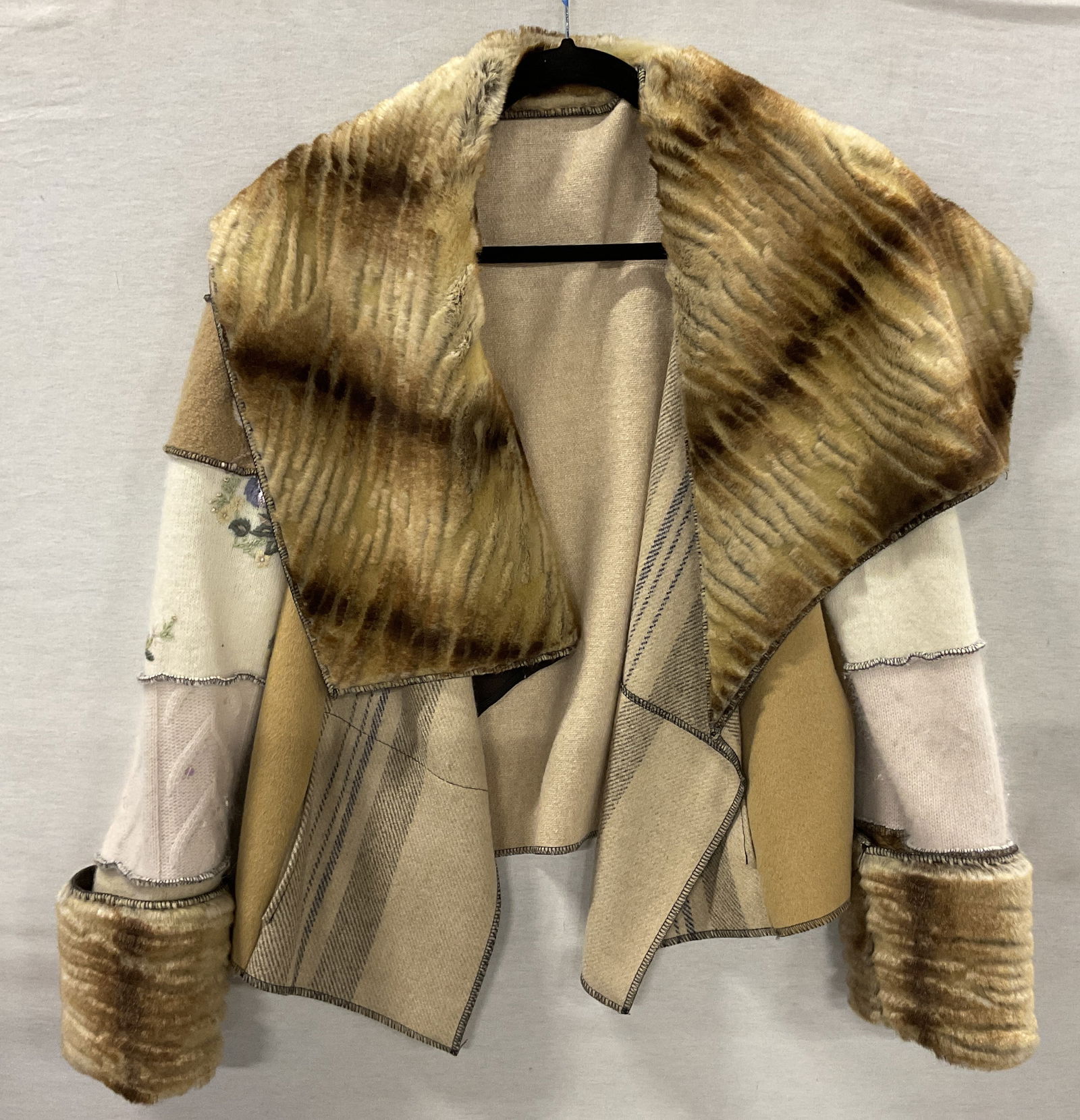 Vtg Embroidered Wool & Fur Jacket: Vintage embroidered wool and fur jacket. Wool and fur material. Fur collar in brown and white. Striped design. Embroidered floral motifs in varying colors. Decorative buttons. Front pockets. Off