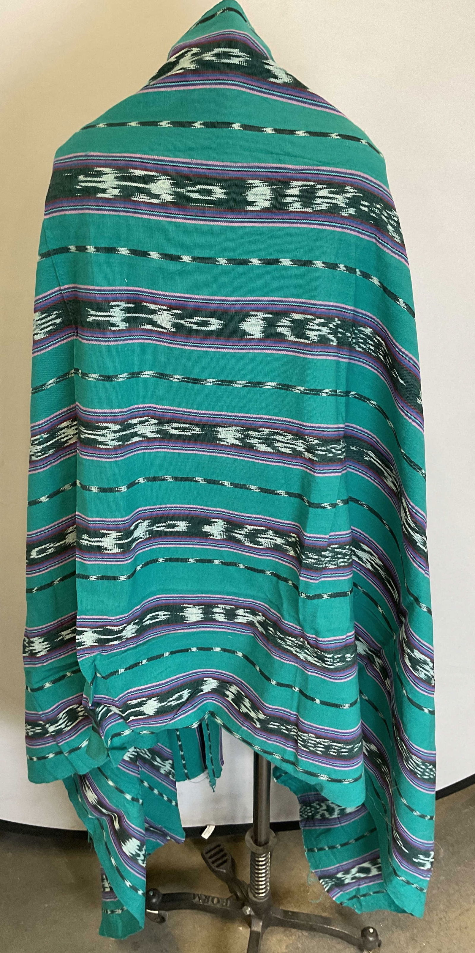 Vintage Blue Geometric Fringed Shawl: Vintage blue geometric fringed shawl. Feels like cotton. Fringed blue trim. Blue background with varying colored geometric patterns. Measures approx 34 x 81 inches. Surface wear consistent with